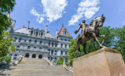 Low angle view of New York state capitol building with statue