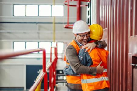 engineers hugging in celebration