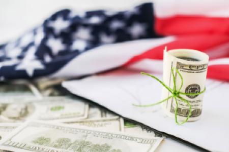 dollar bills on a USA flag