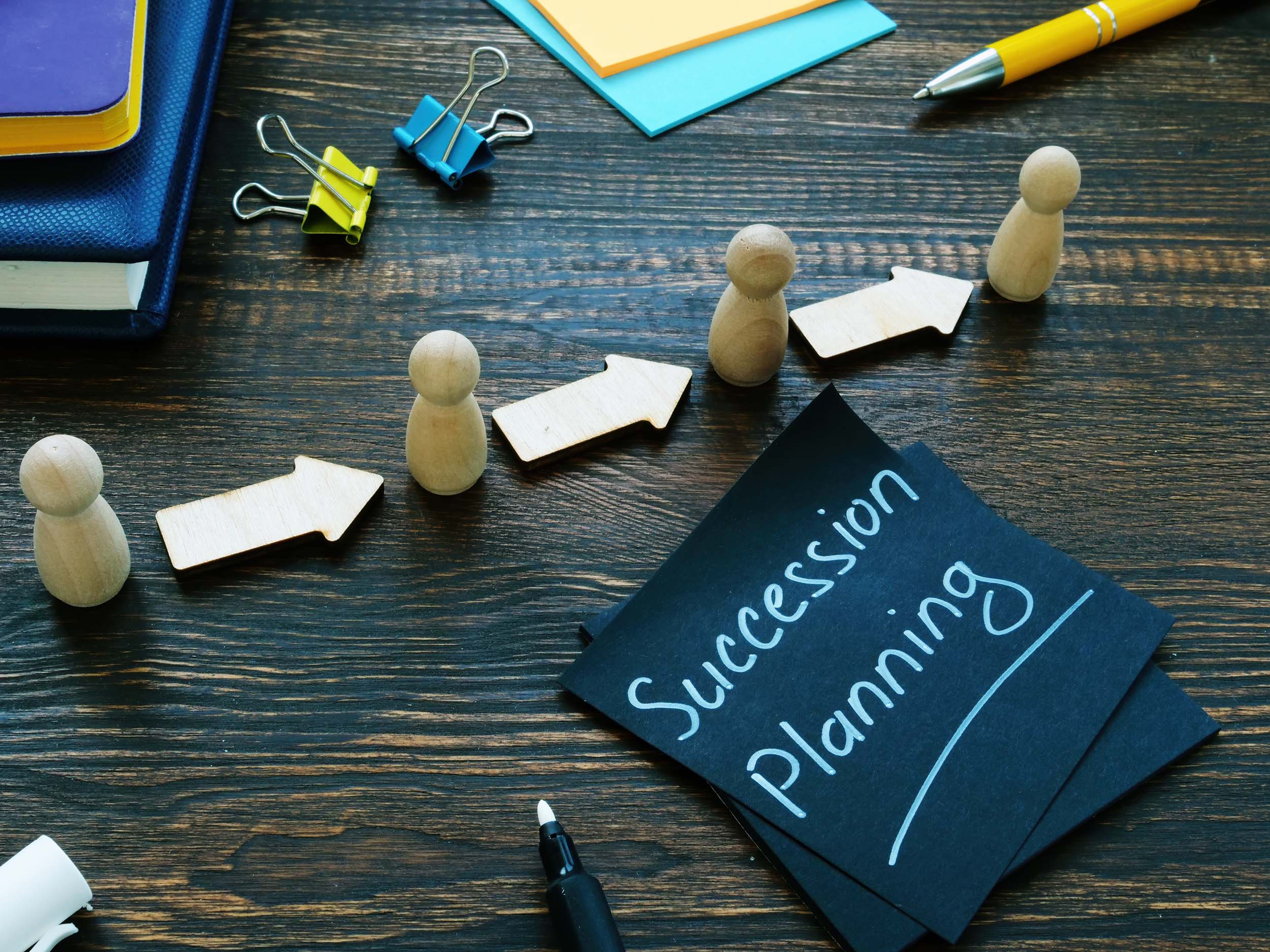 succession planning text, figurines and arrows