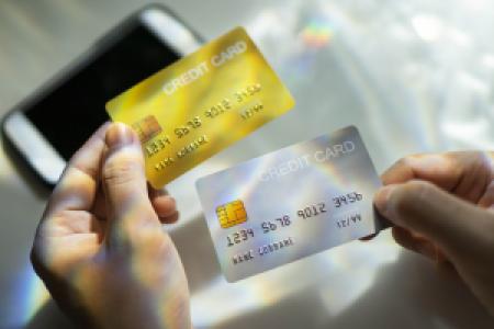 a person comparing two credit cards