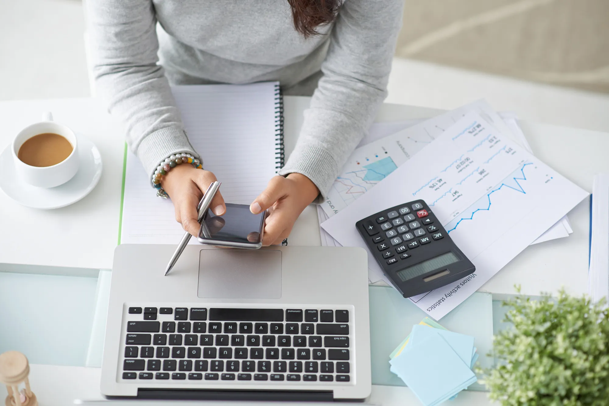 an accountant working with charts and a computer