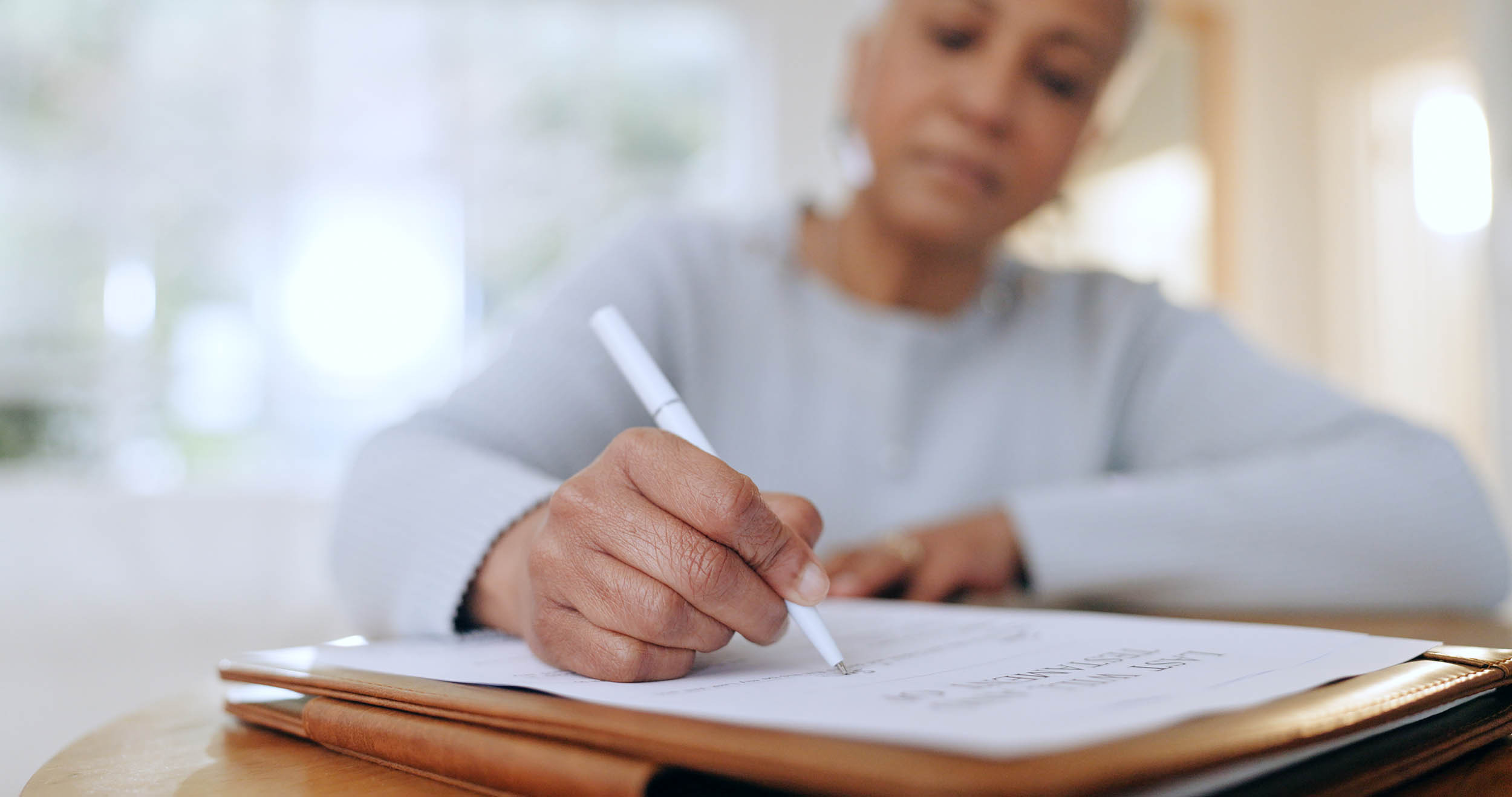 a senior signing insurance papers