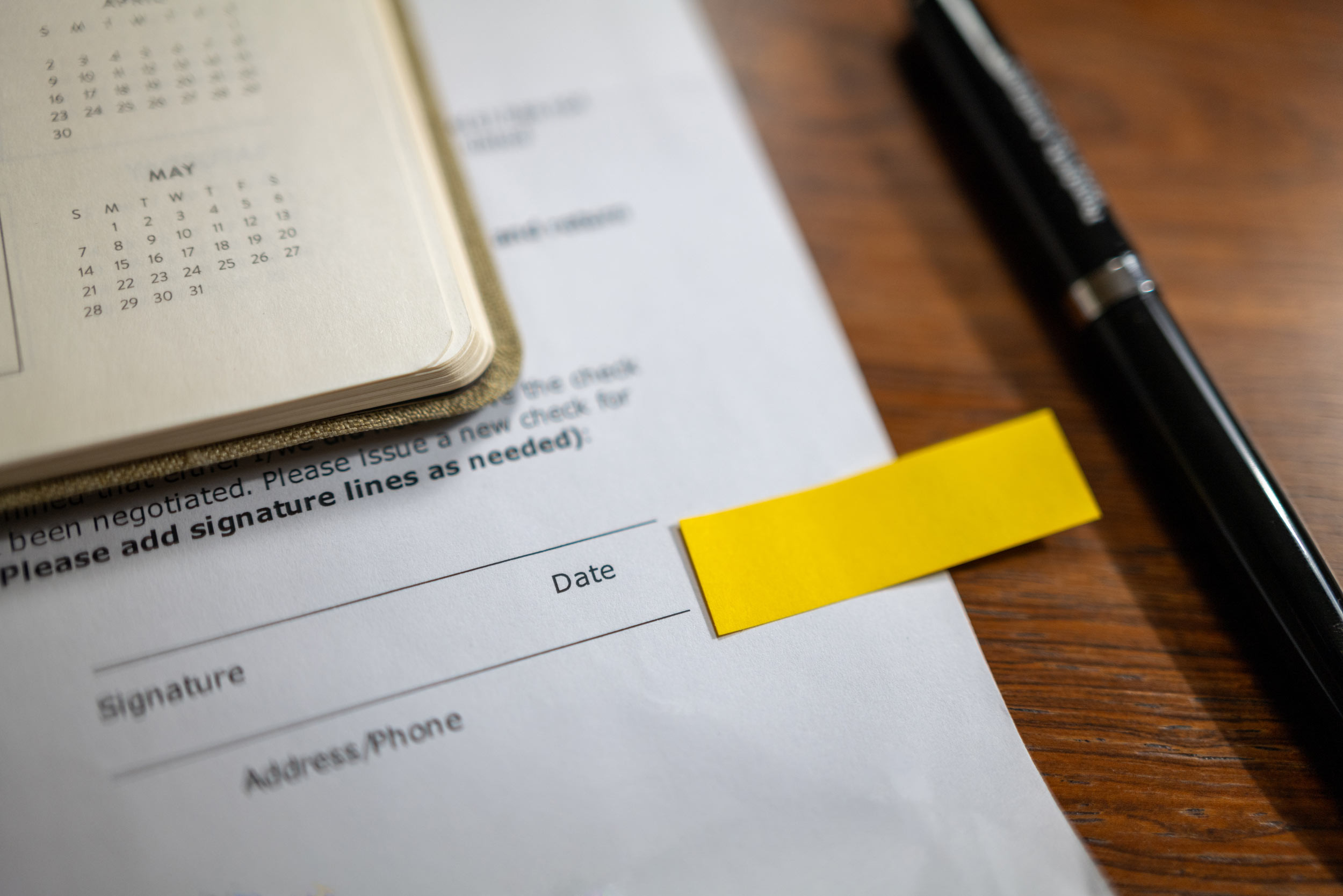 sticky note on a document signature field