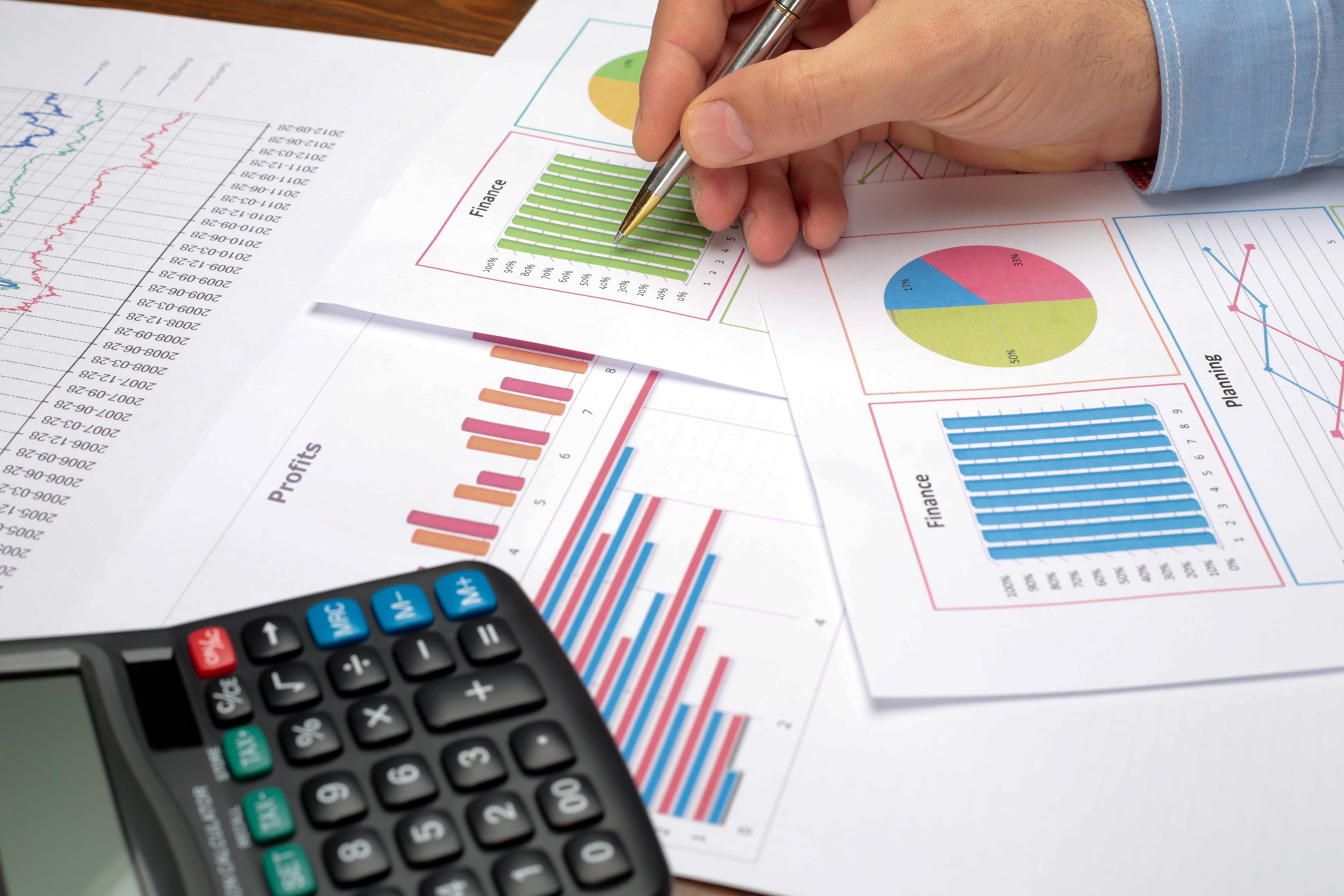 An accountant reviews a print-out of graphs