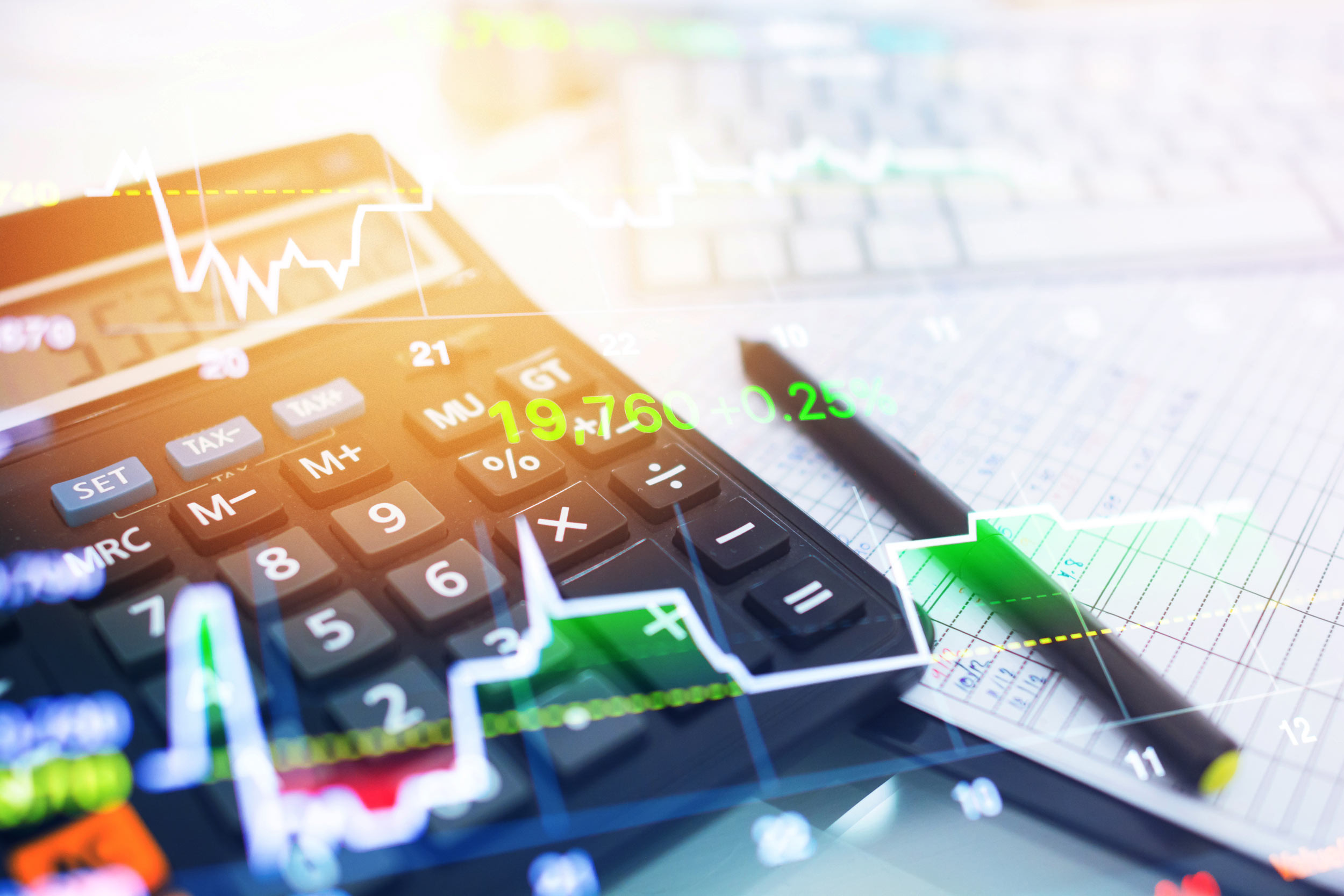 A calculator and pencil on desk with aesthetic overlay of graphs and numbers