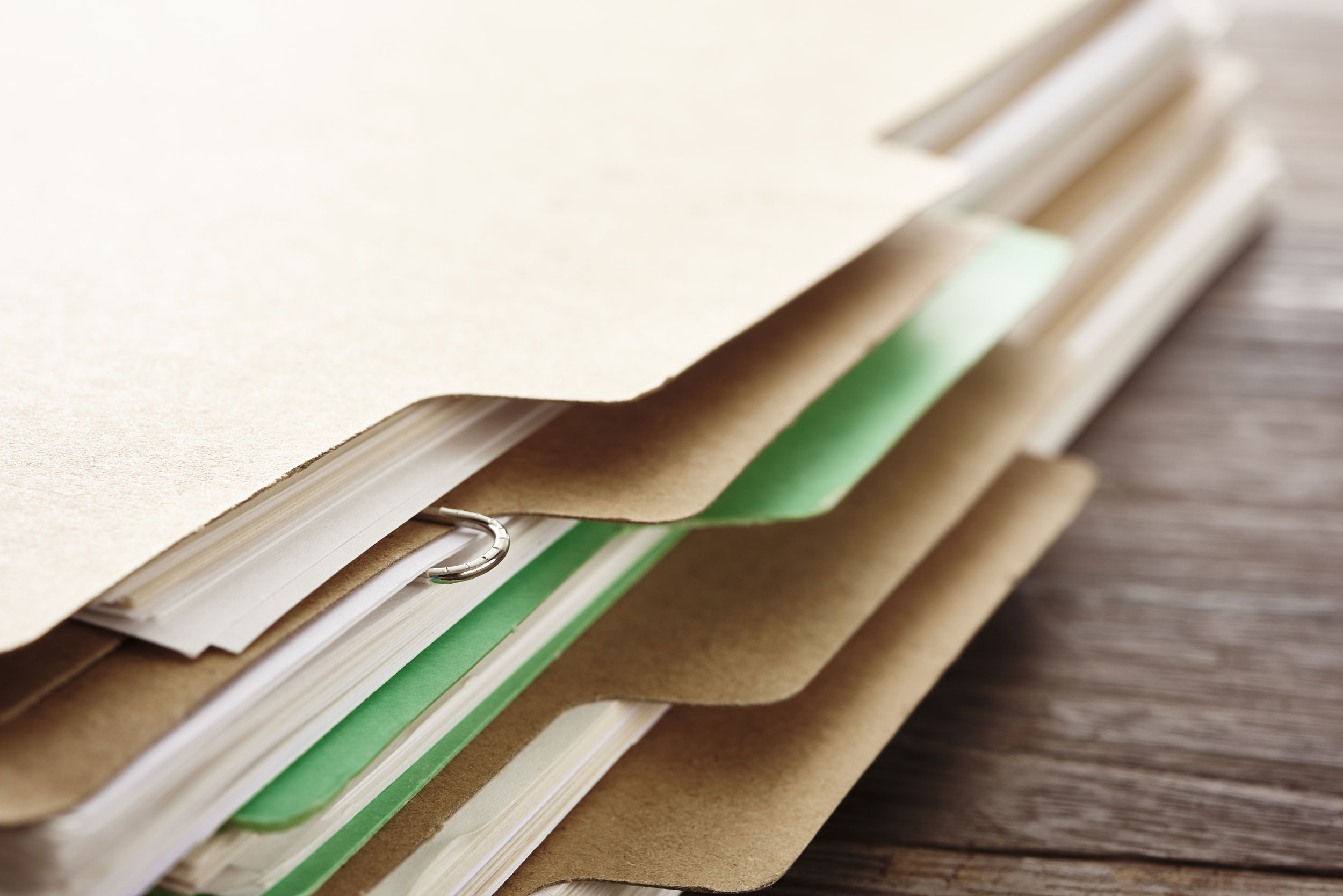 Close-up of a stack of folders on a bookkeeper's desk