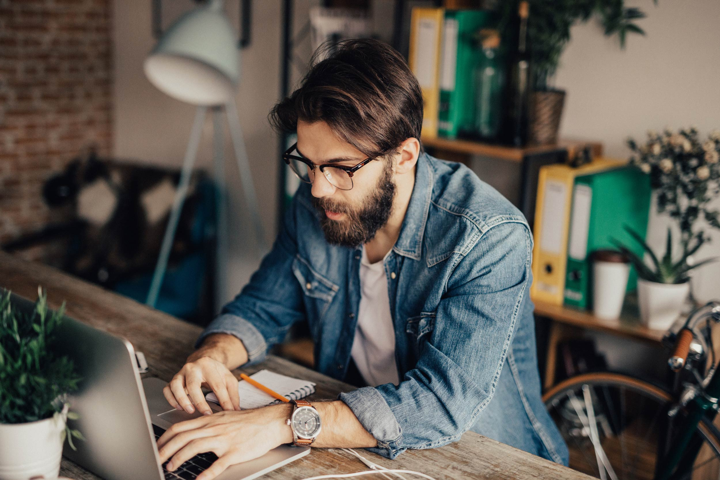 Male entrepreneur works on his laptop at his desk
