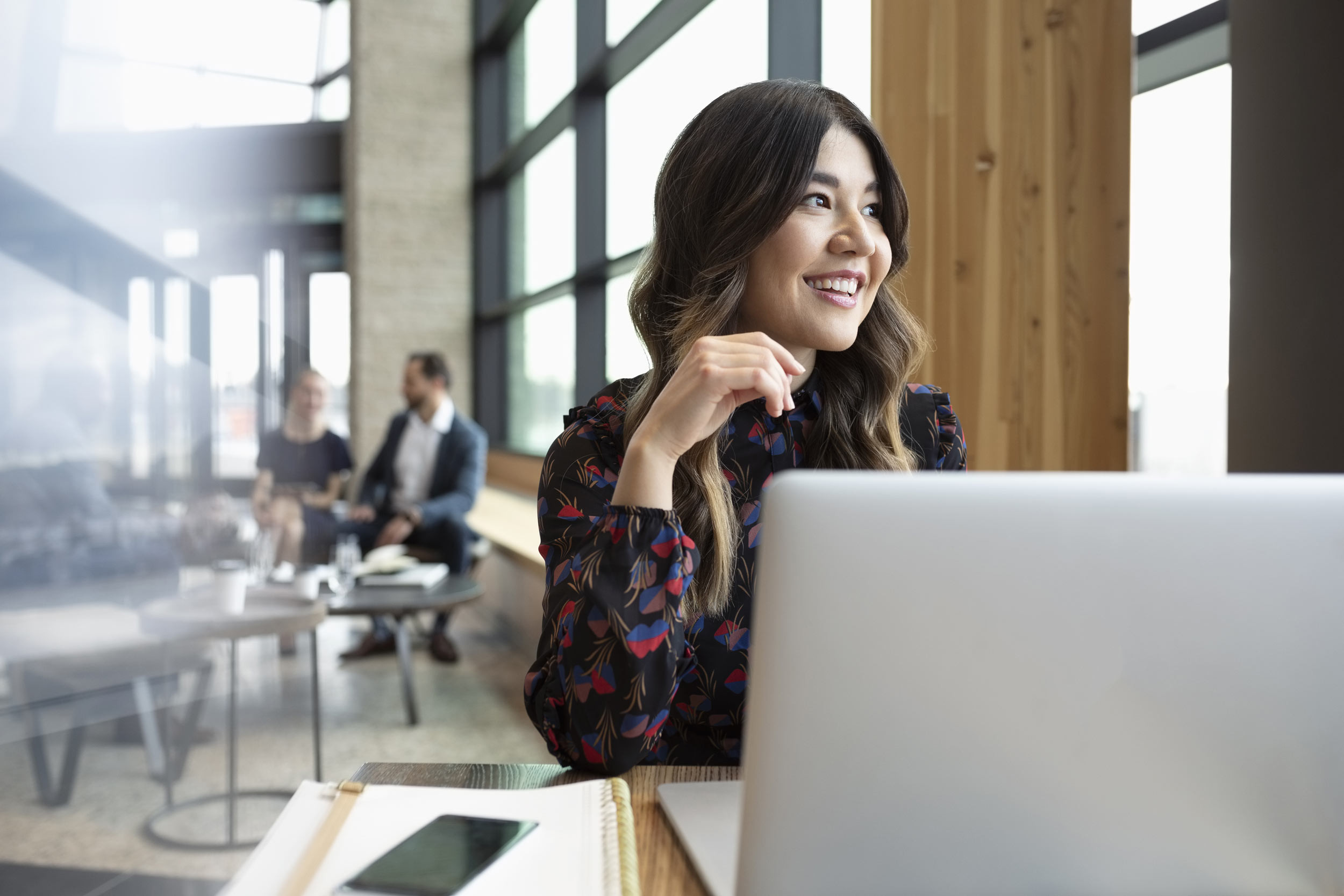 Female entrepreneur staring out the window of an office