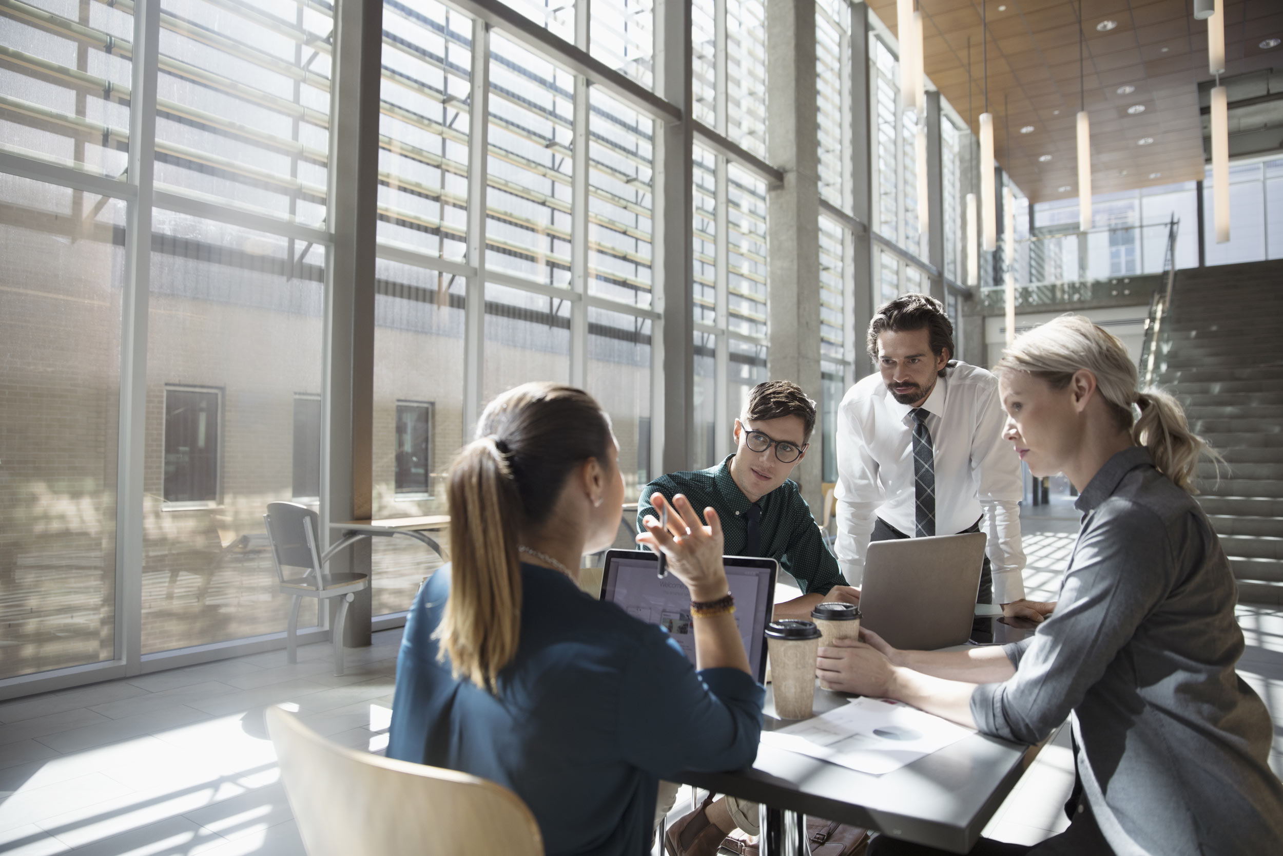 Business professionals reviewing tax and payroll compliance reports