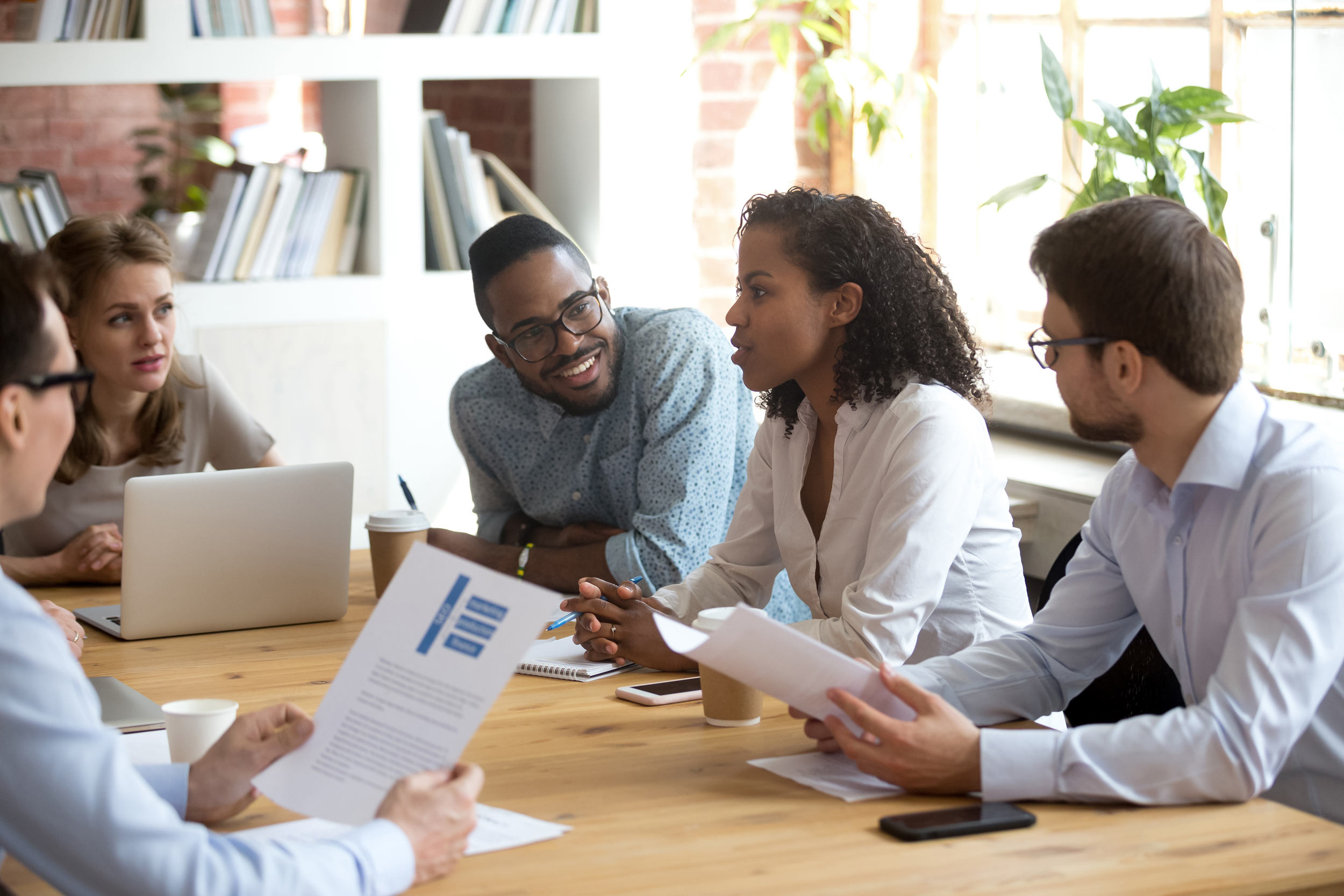 Coworkers in a discussion during a business meeting