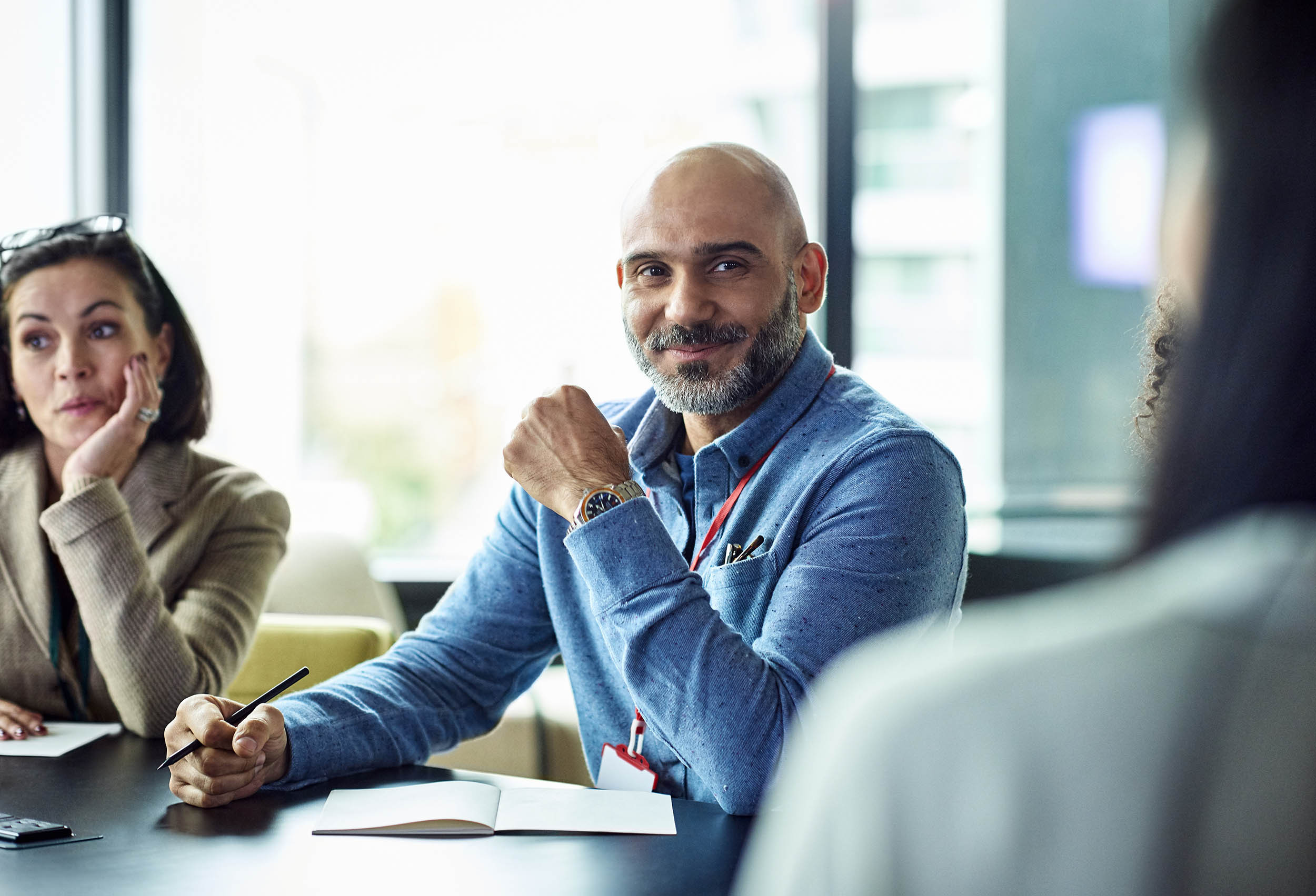 Close-up of a businessman smiling during a business meeting.