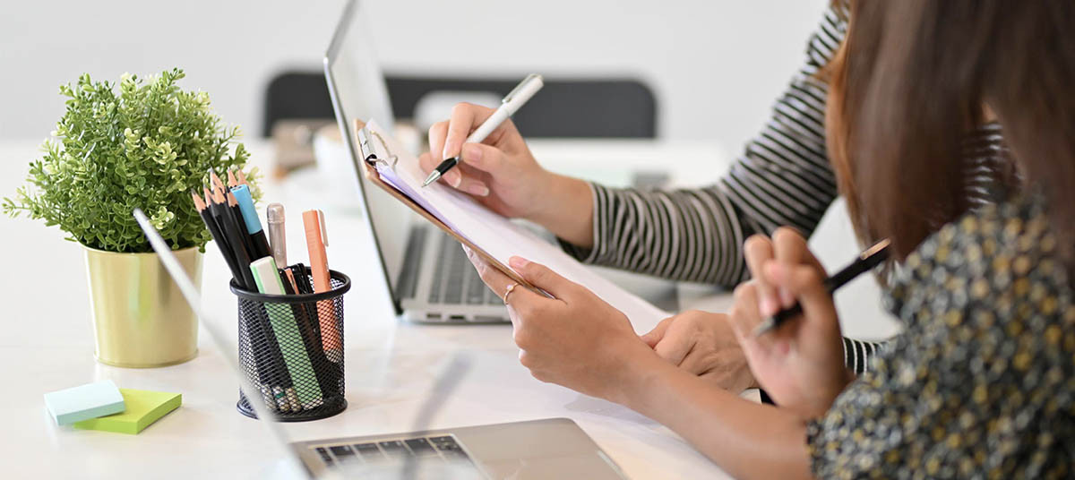 a person assisting another filling out forms