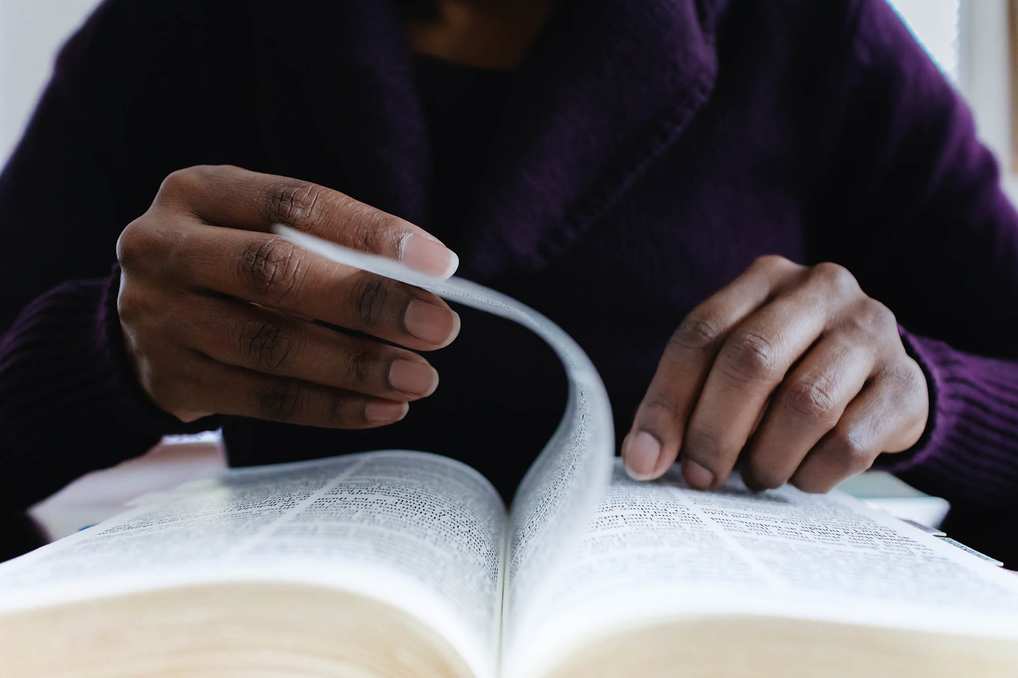 clergy turning the page of a religious book