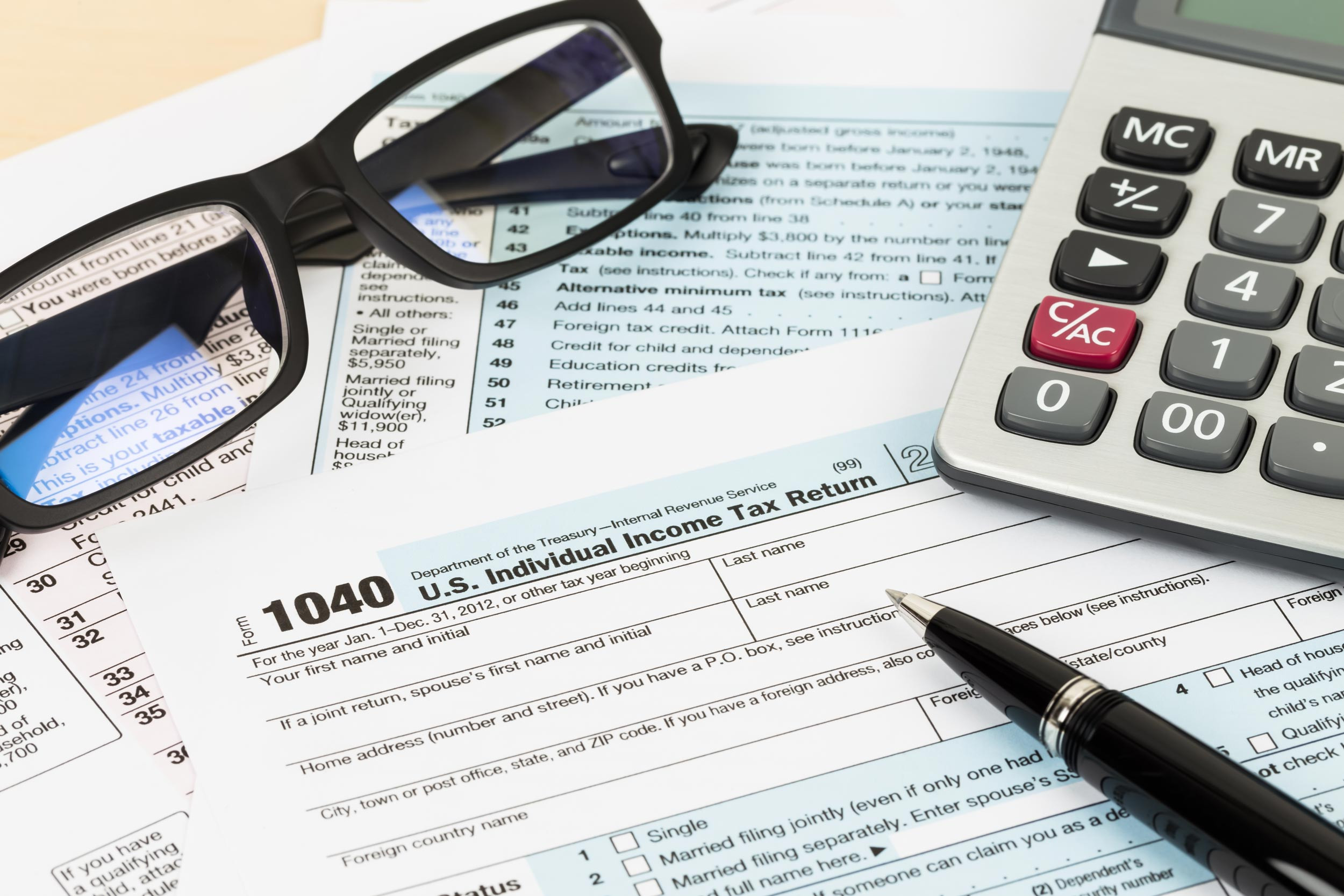tax form with glasses and calculator