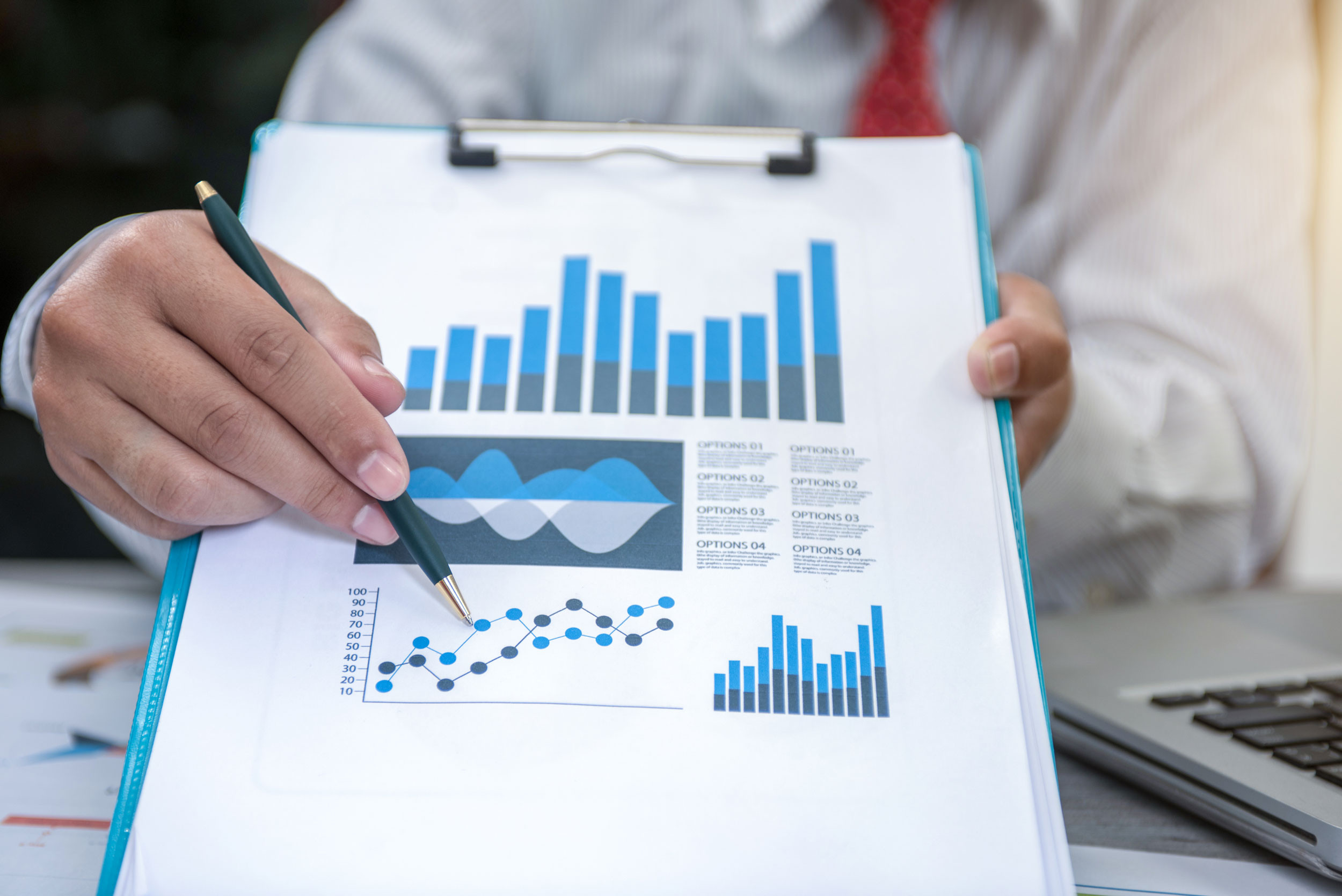 business analyst explaining charts on a document