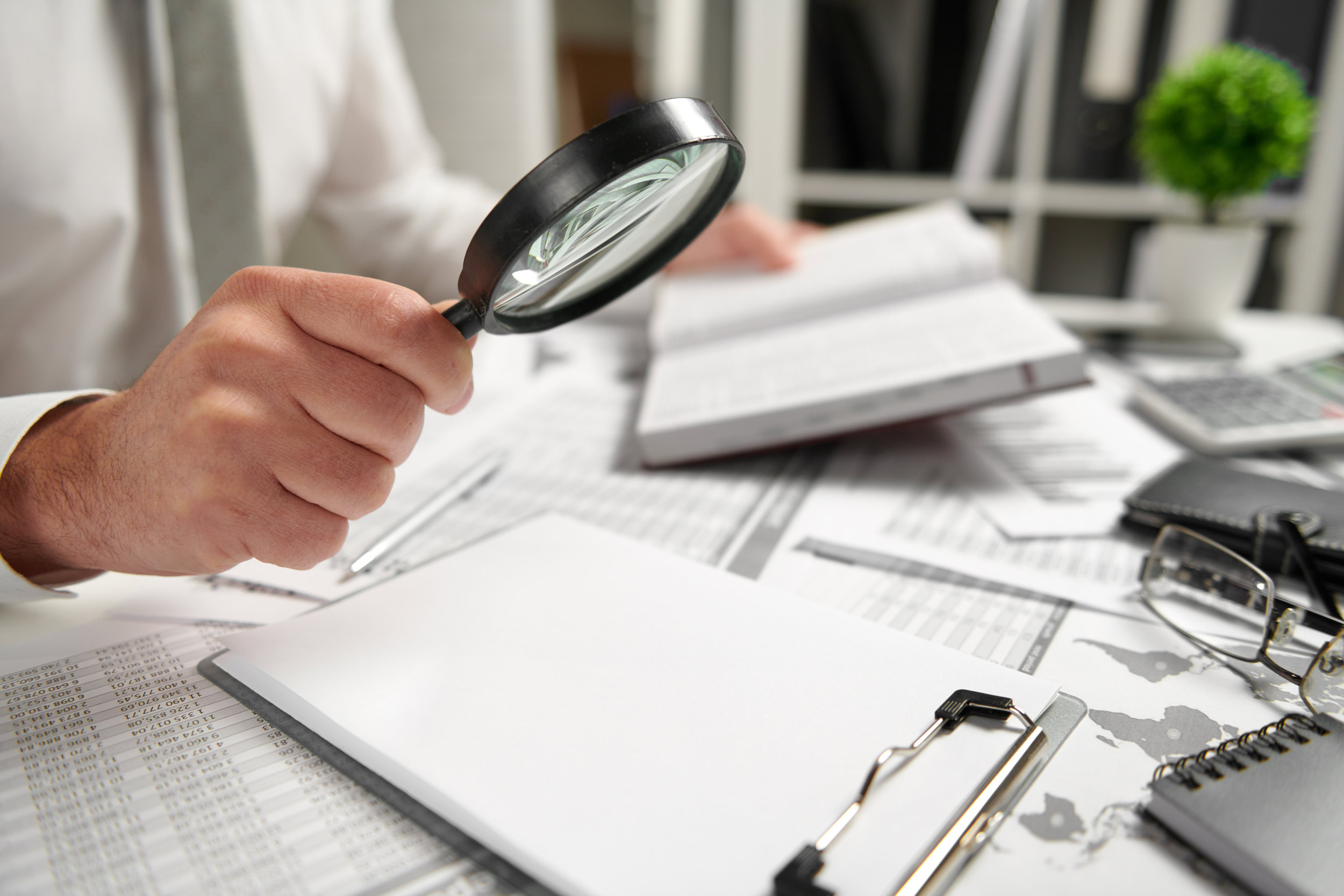 business person calculating finances and analyzing reports