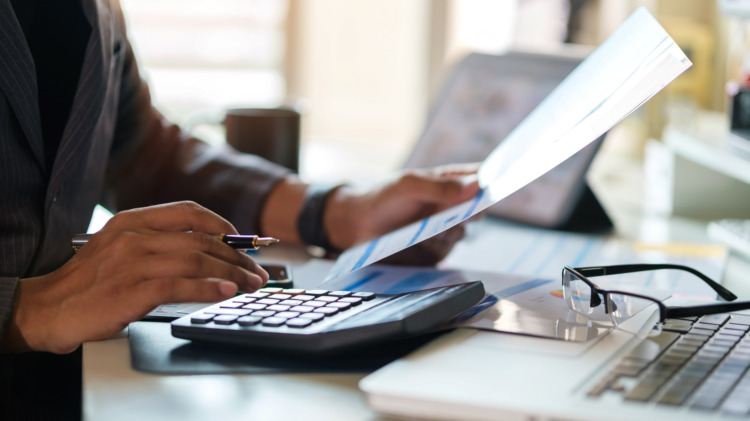 man using calculator for calculating finance and statistics
