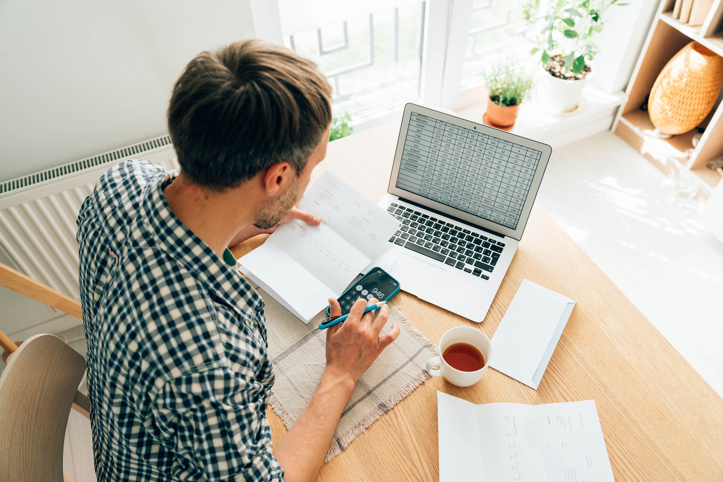 man calculating personal finances at home