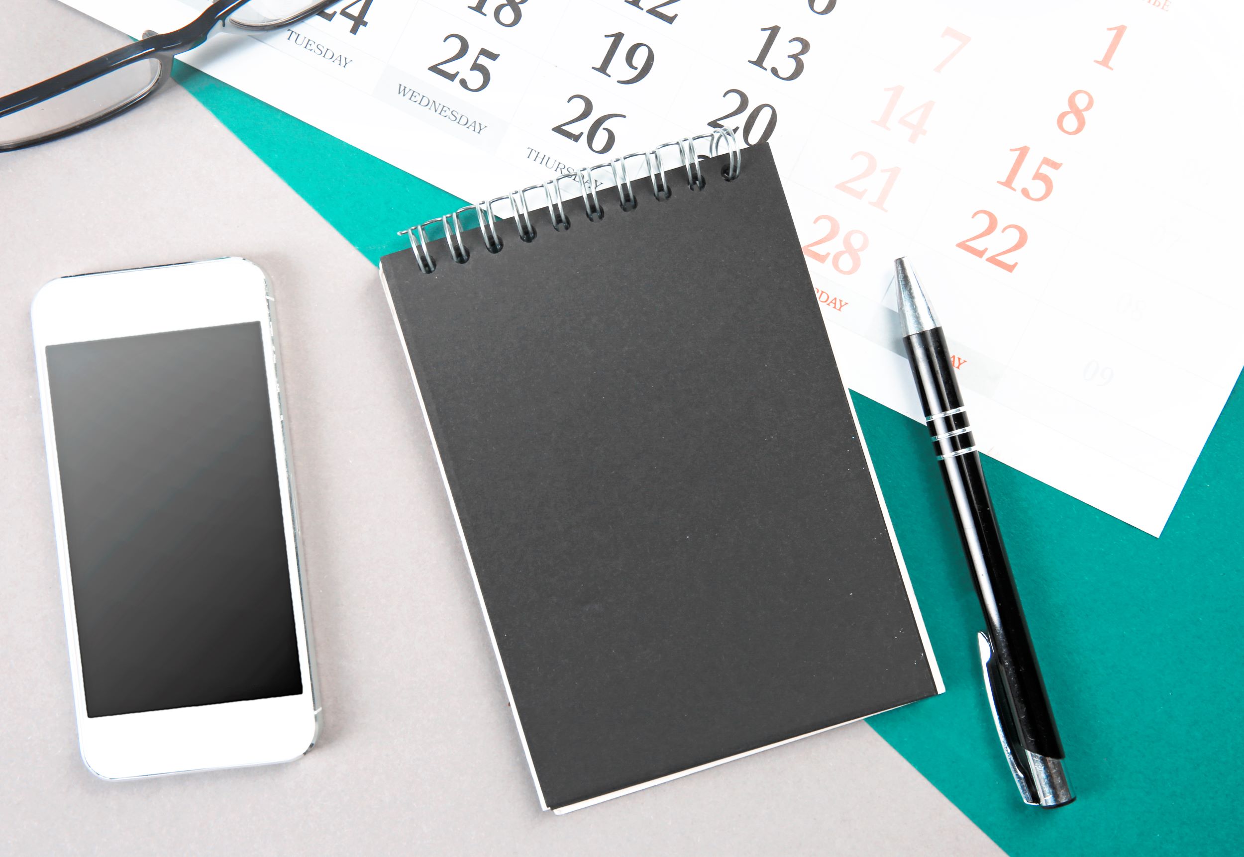 Calendar and notebook on a desk