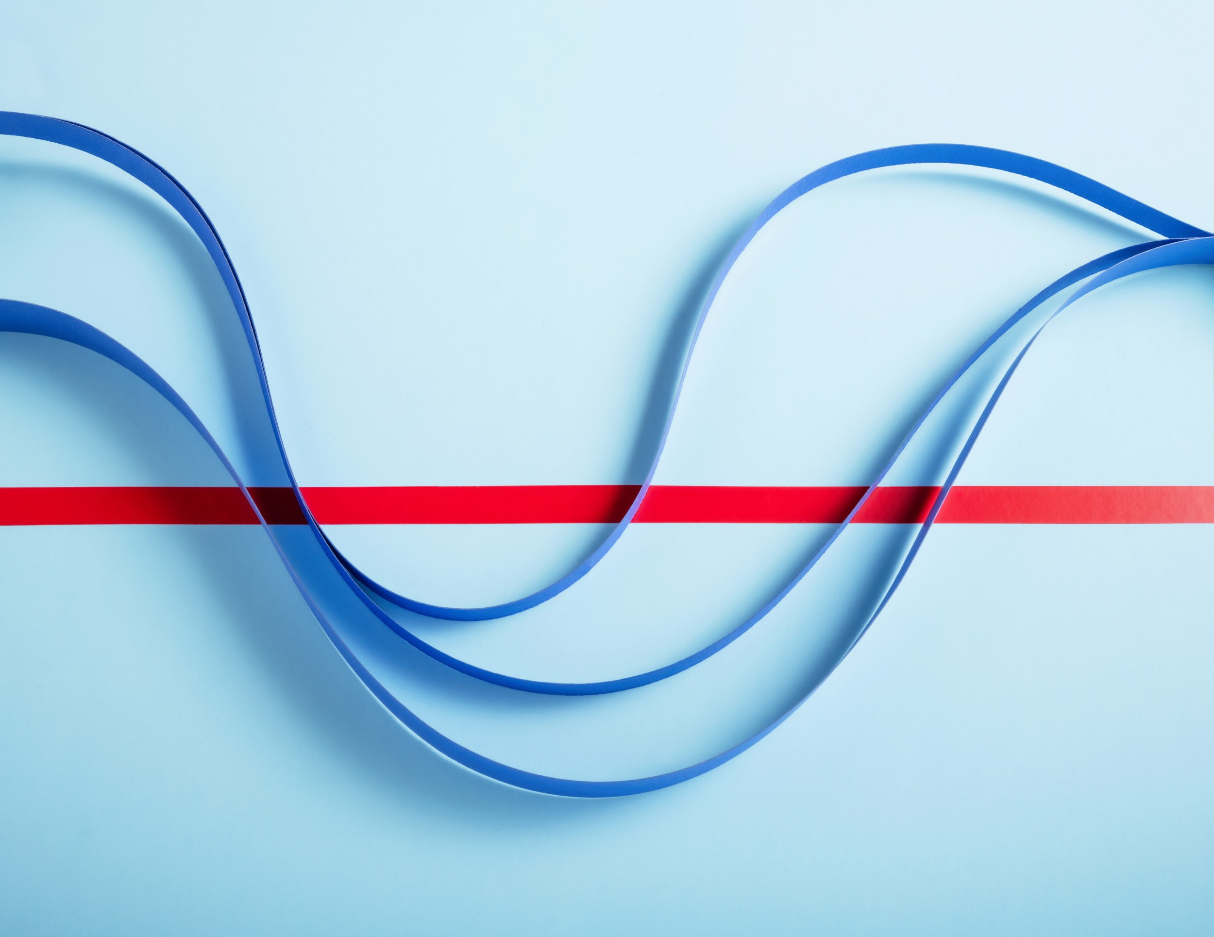 strips of wavy paper flowing over red line