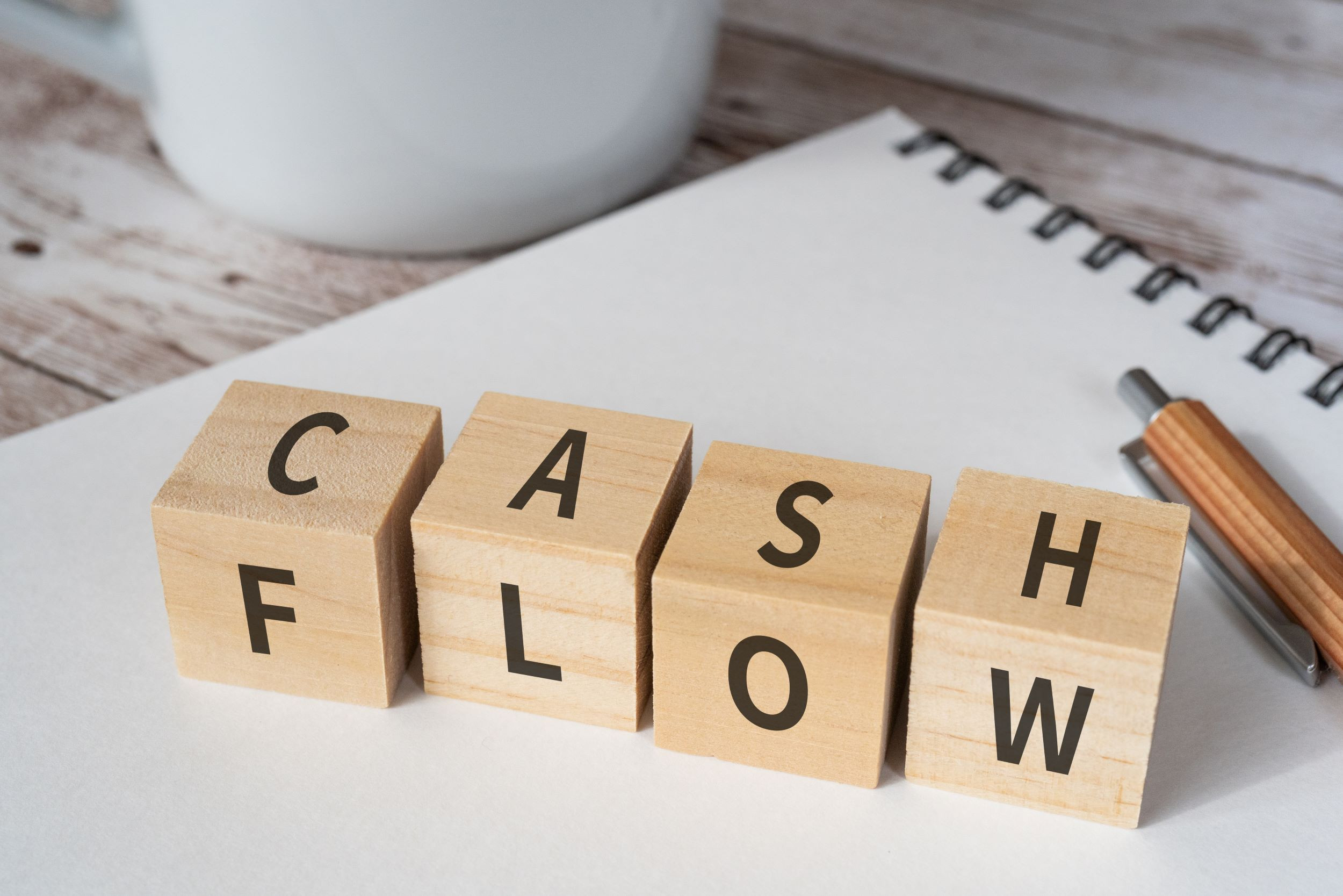 wooden blocks spelling cash flow on a table