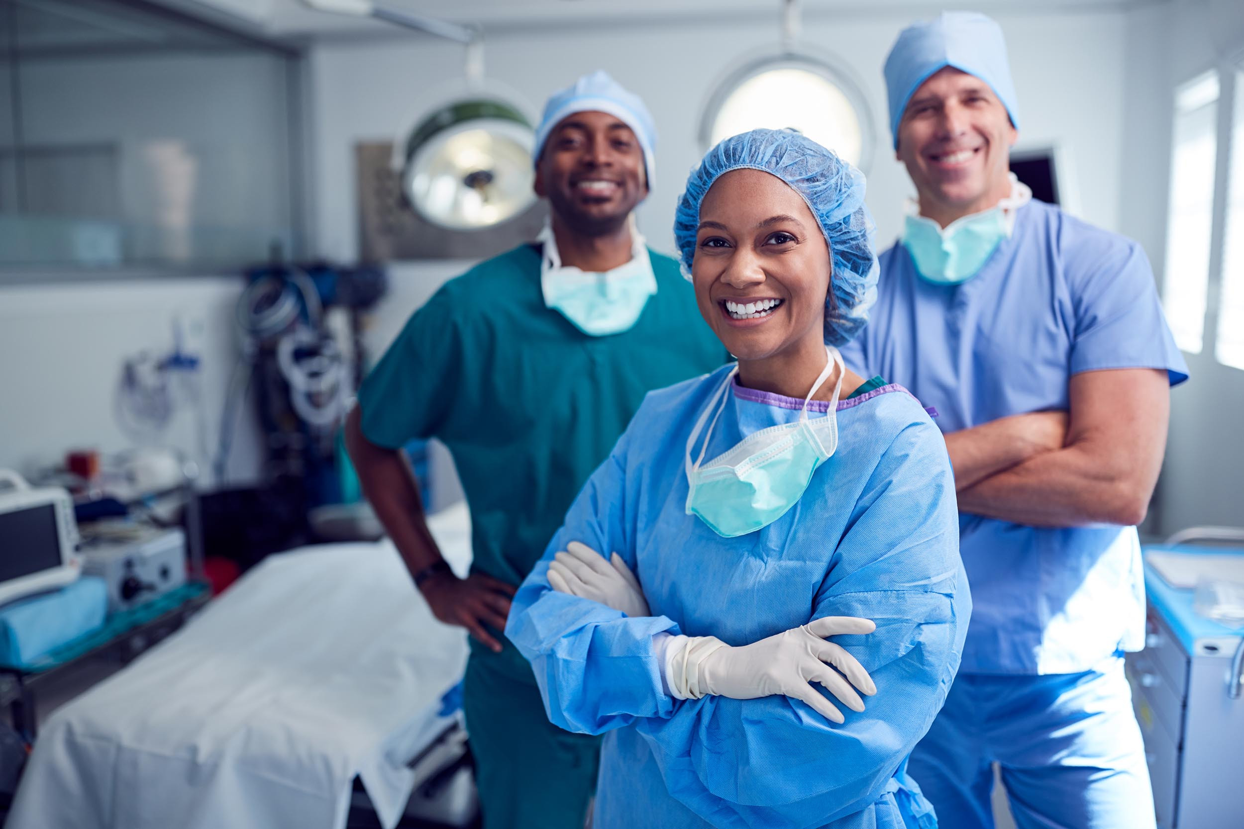 Portrait of multi-cultural surgical team standing in a surgical room