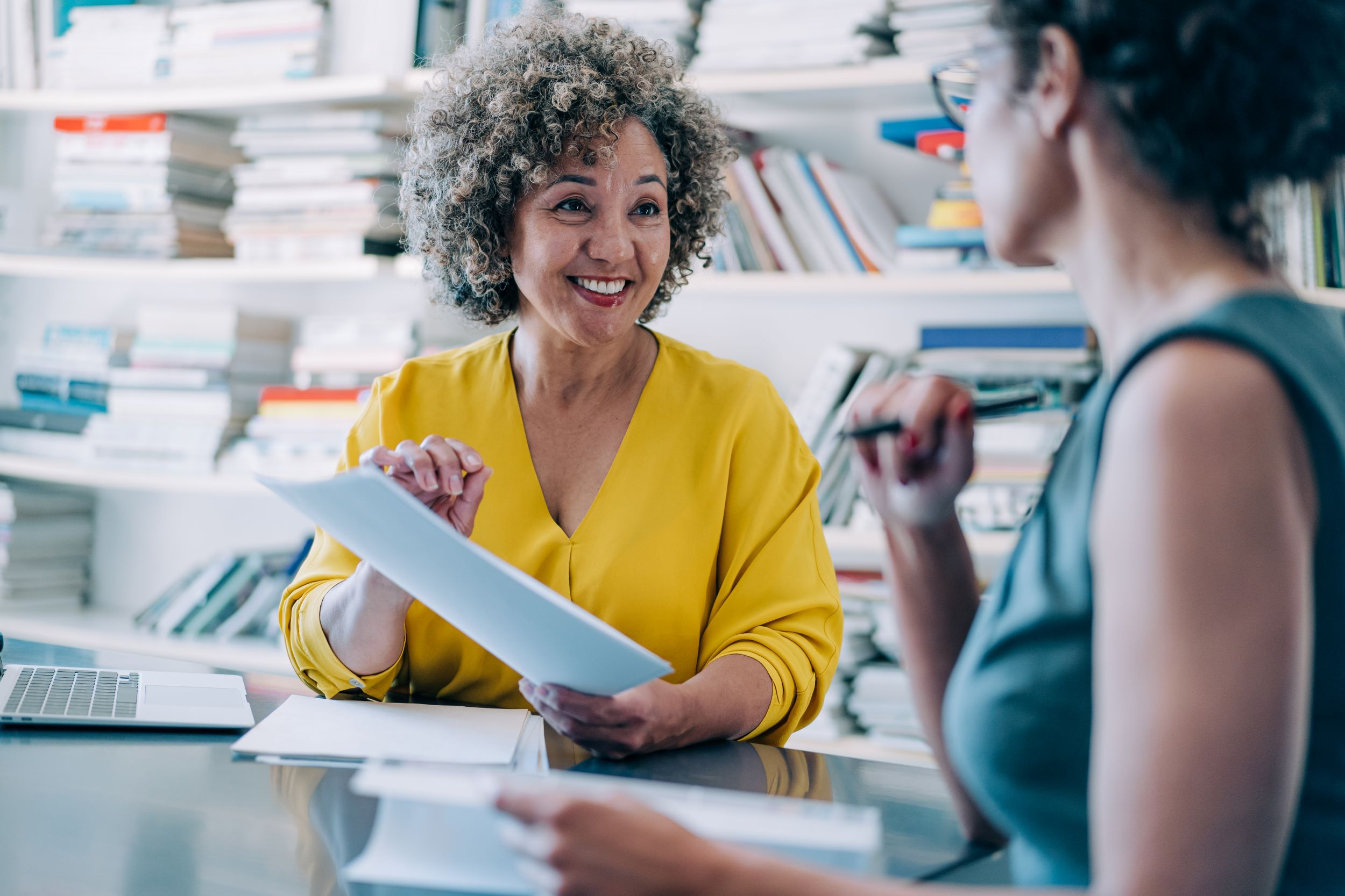 two coworkers discussing about business documents
