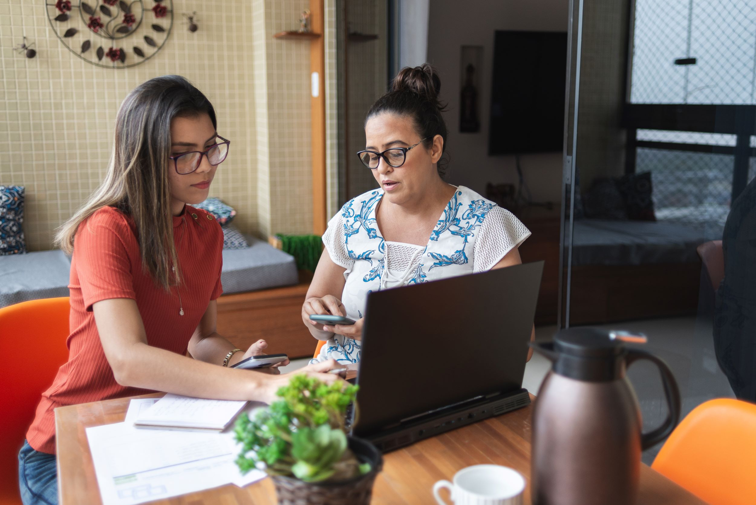 a mother and daughter calculating taxes and finances