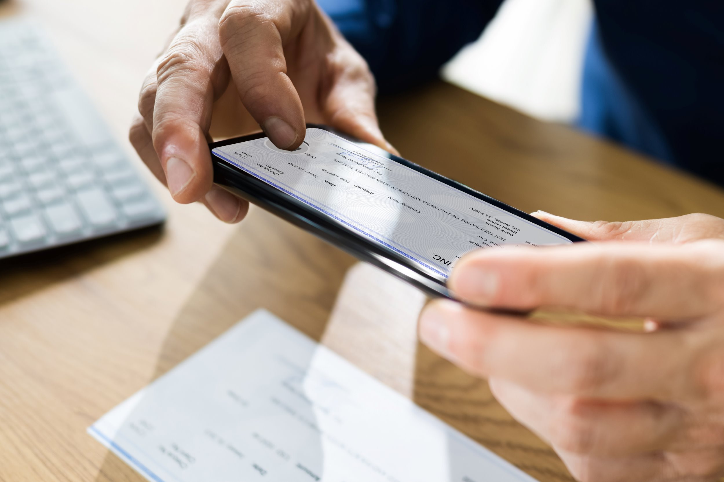 person using their phone to deposit a paycheck