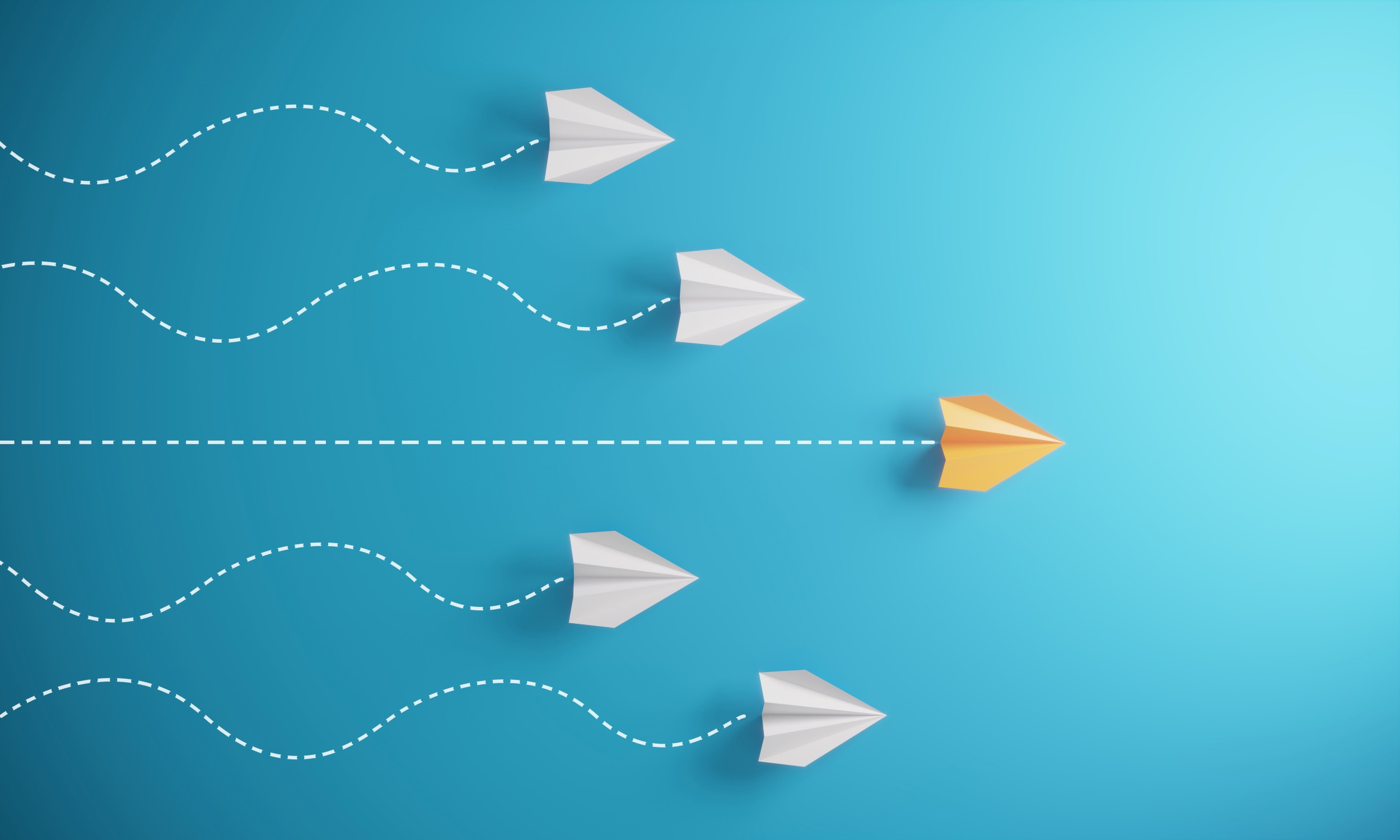 a yellow paper plane flying past the others