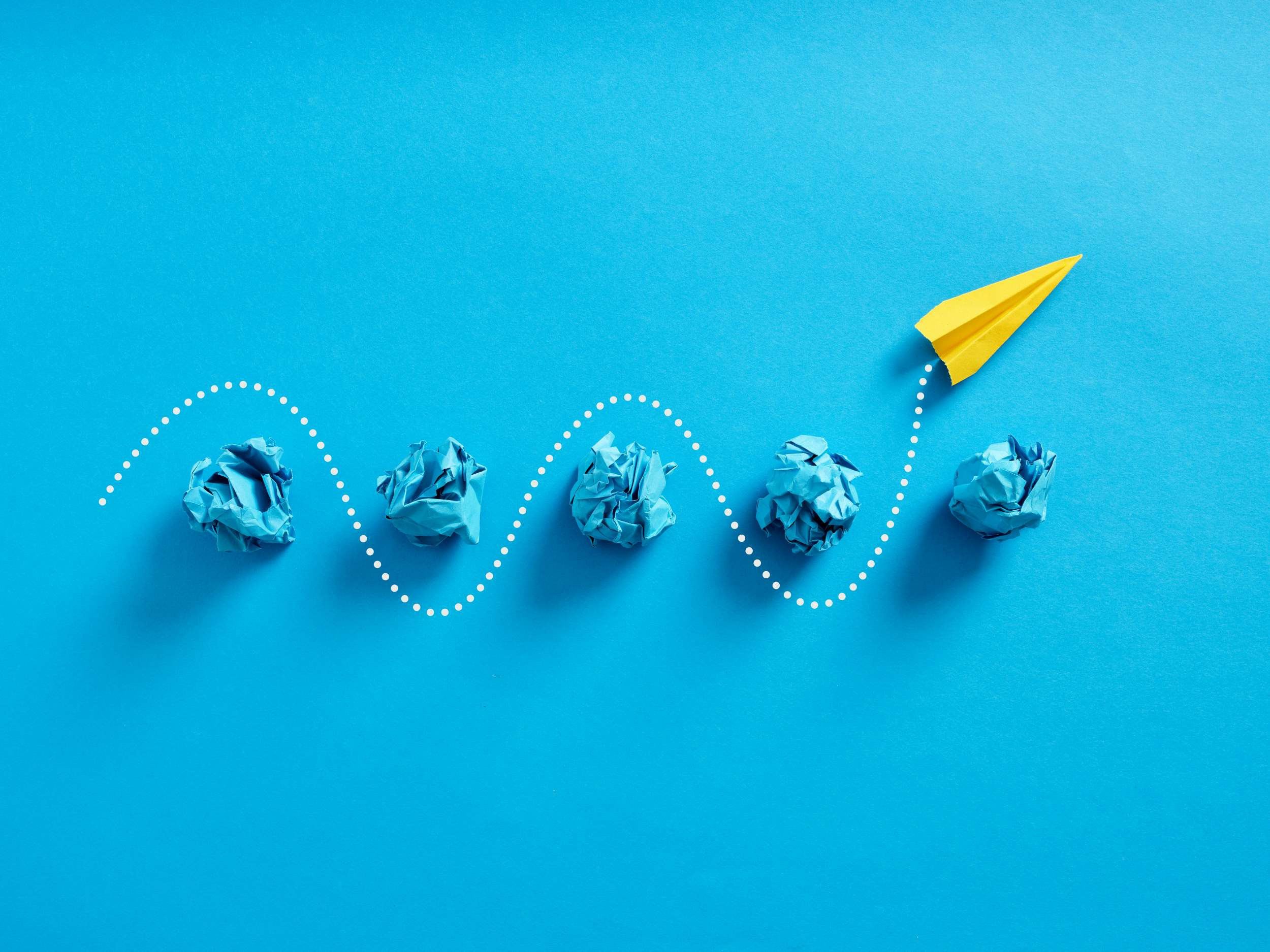 a paper plane navigating through obstacles