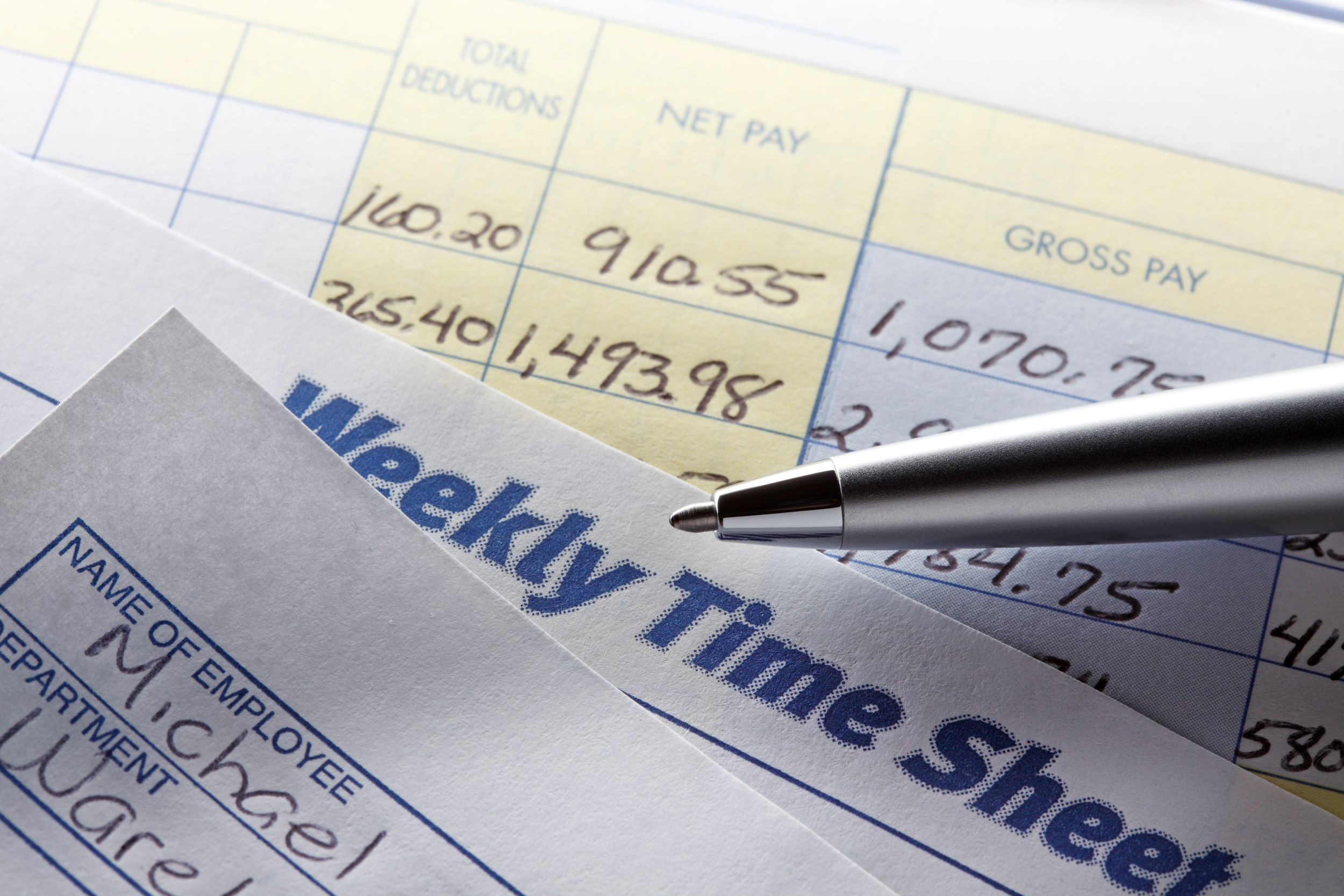 a pen on a weekly timesheet