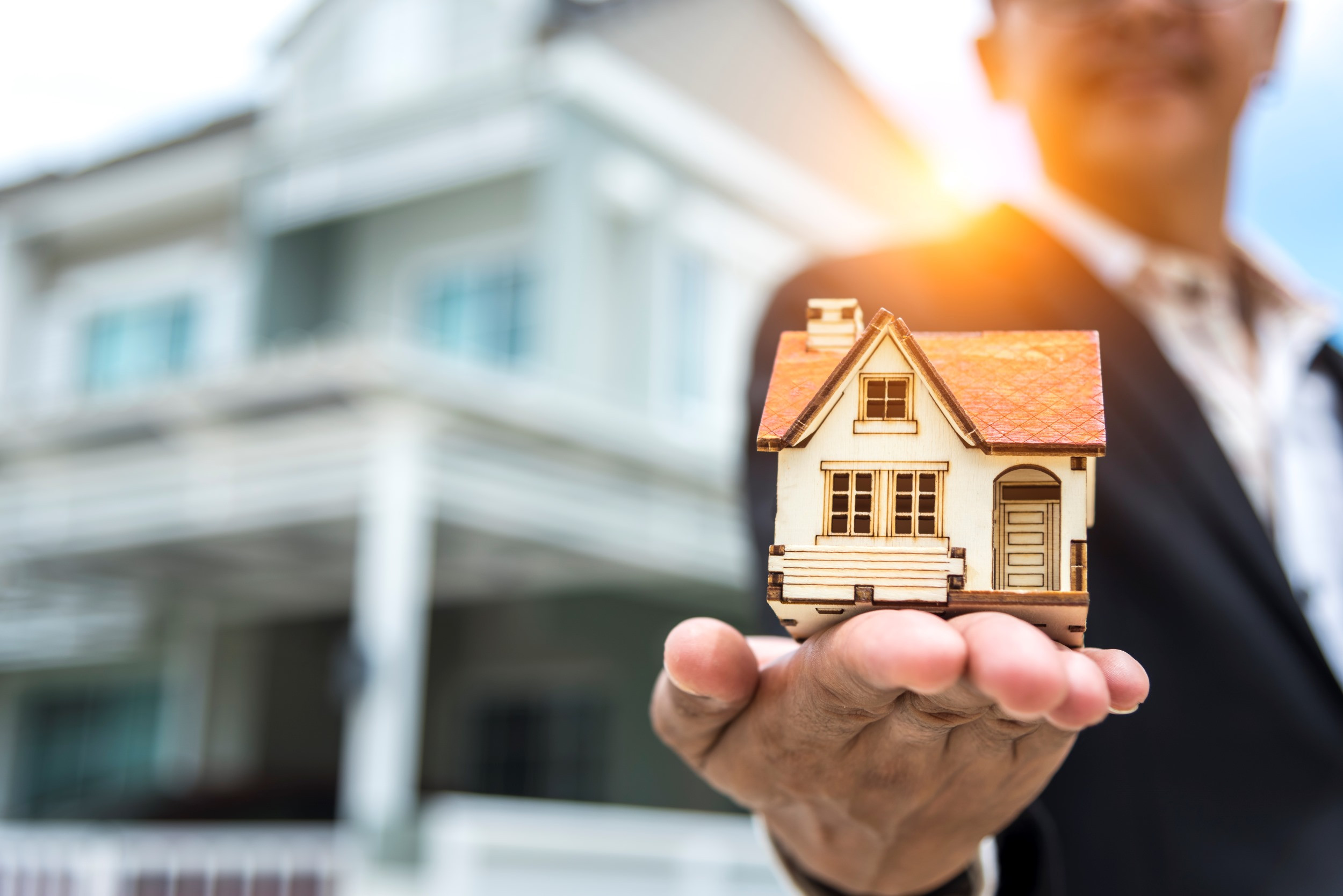 a real estate agent standing in front of a building