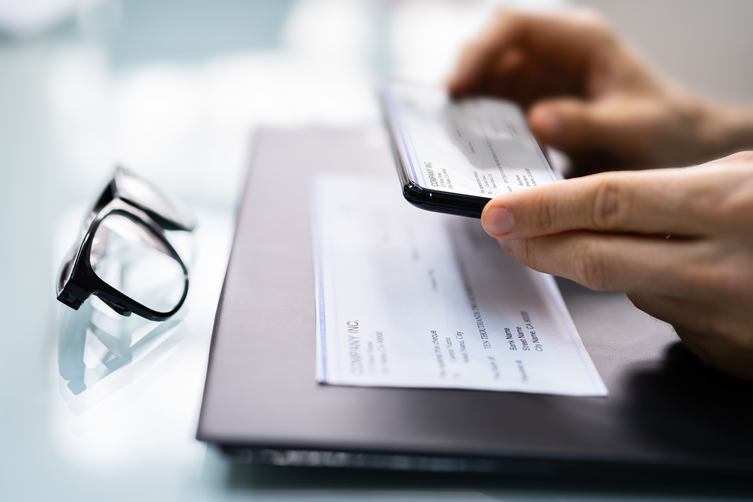 person using their phone to deposit a paycheck