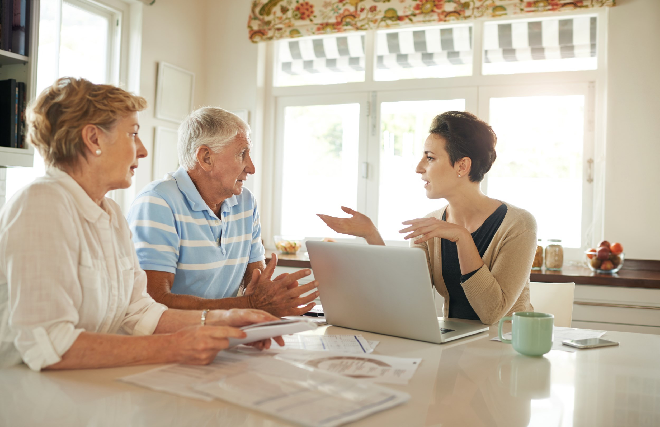 a financial consultant talking with a senior couple