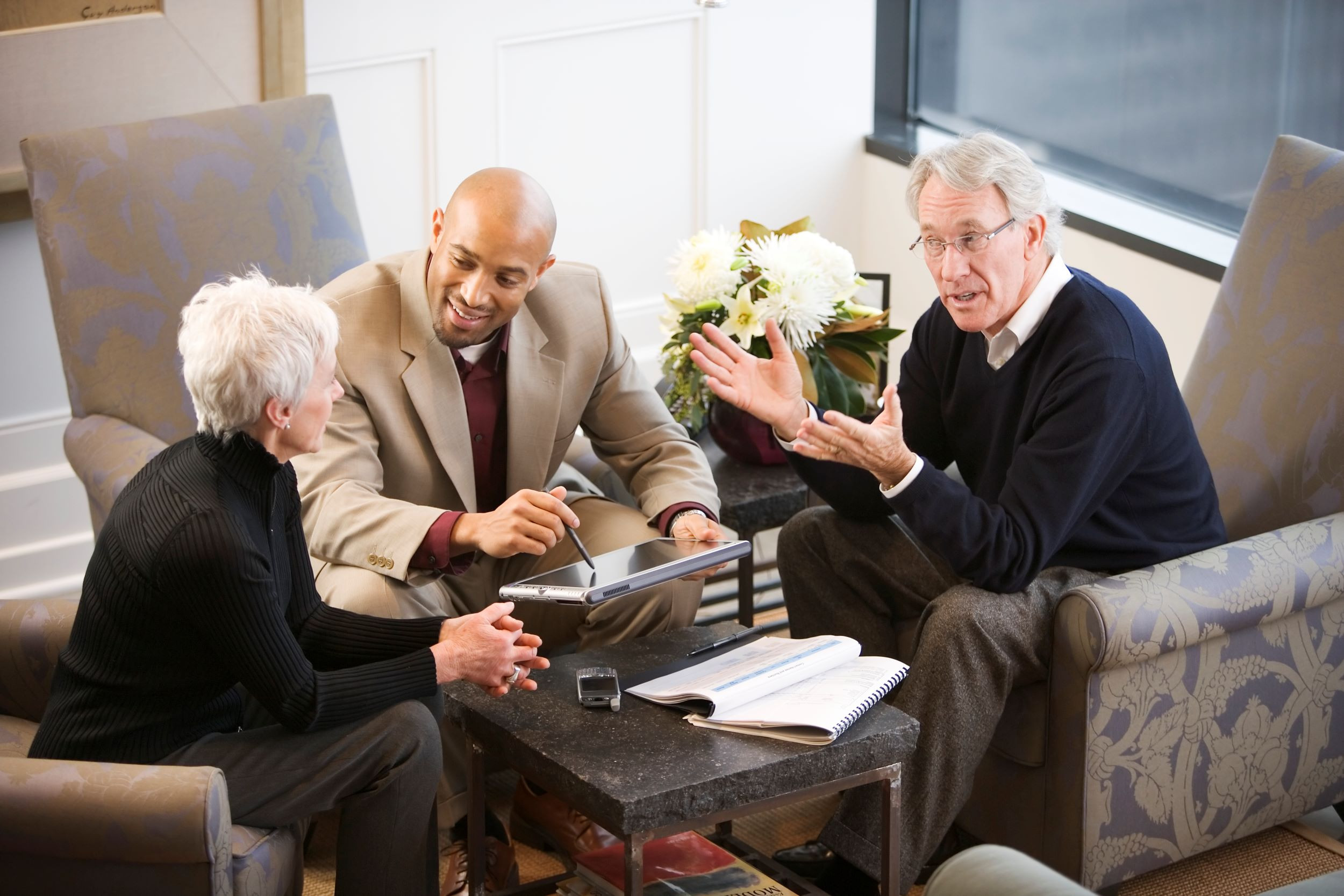 a financial consultant talking with a senior couple