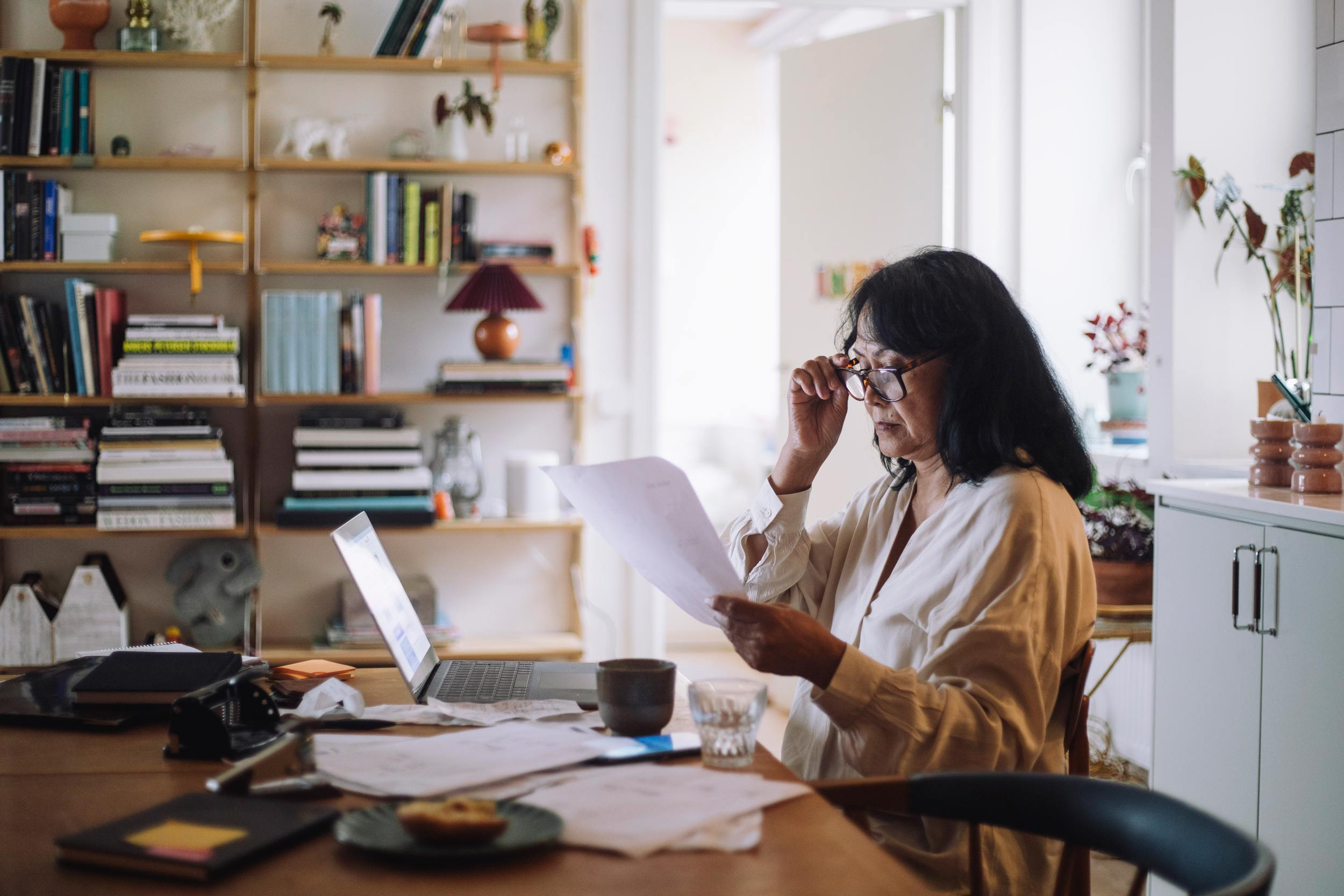 a woman looking over financial documents at home