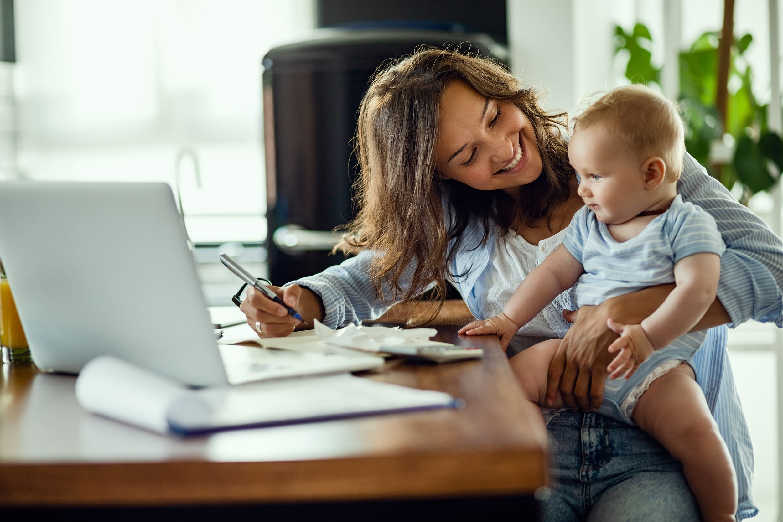 mother doing taxes at home with a child