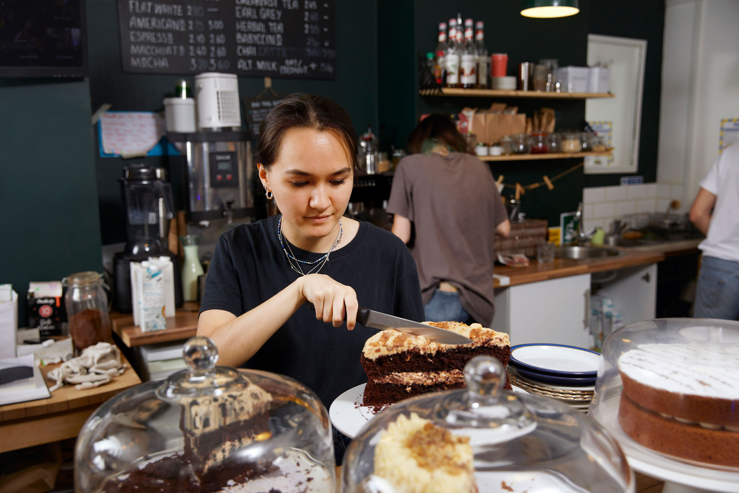 a teenager working part-time at a cafe