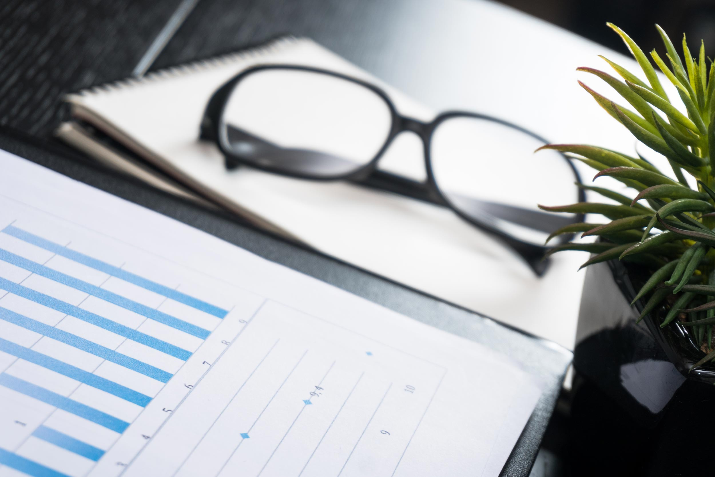 eye glass and accouting graph document on the desk