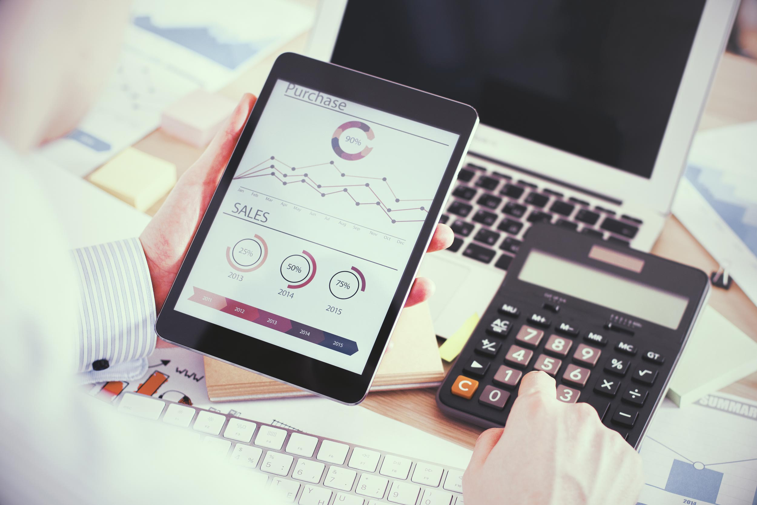 a person calculating the purchase and sales transactions using the calculator