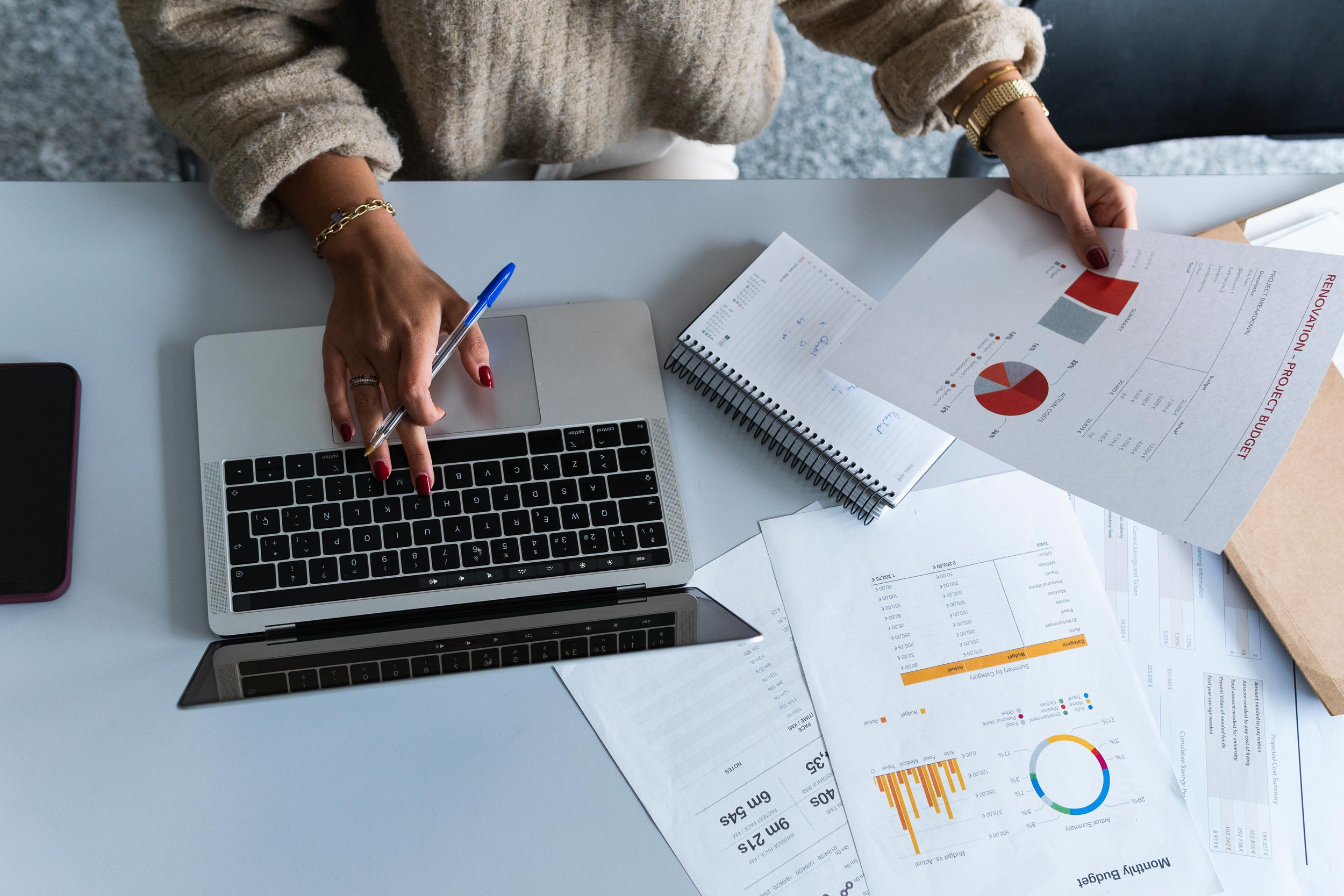 person reviewing the graph documents using laptop