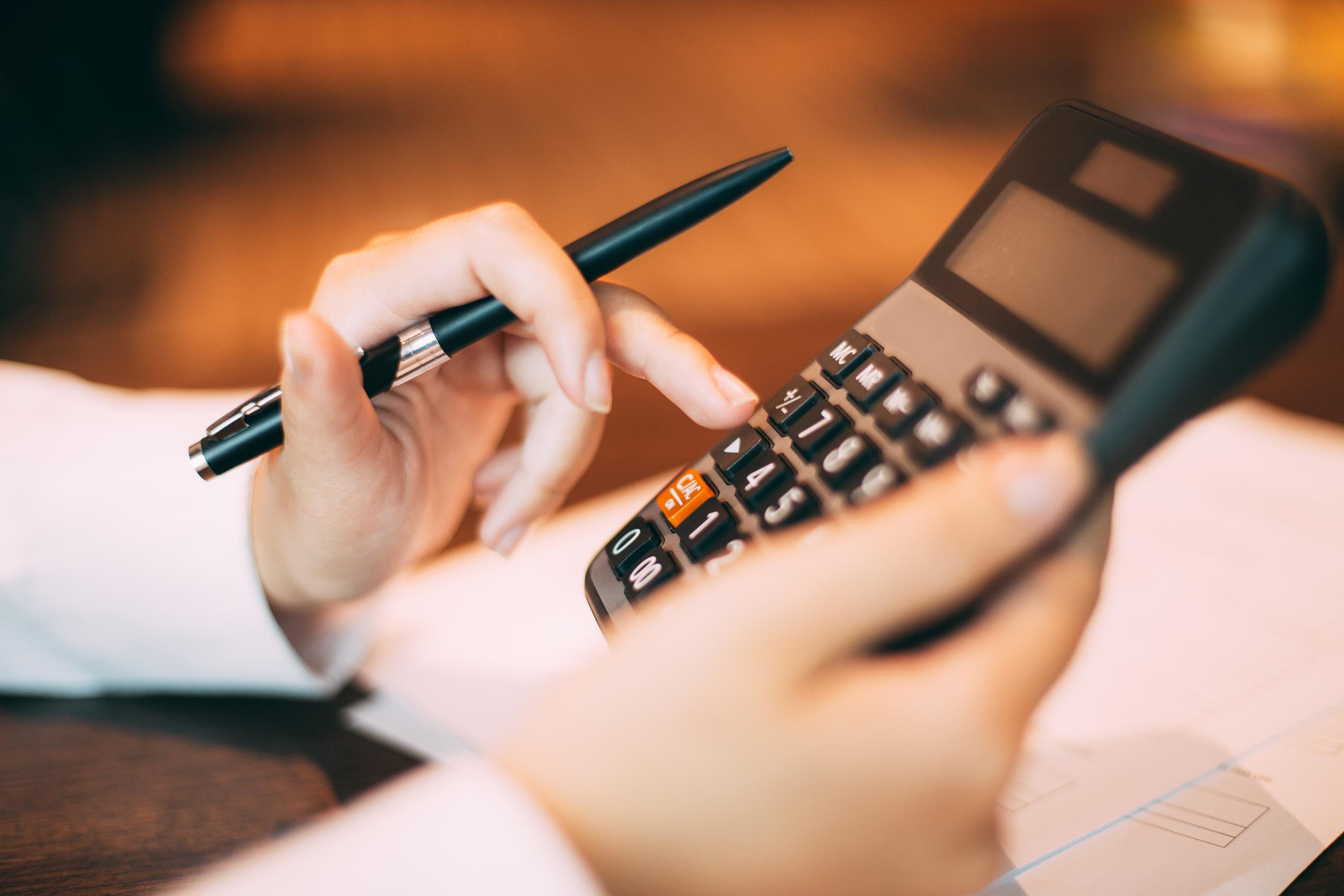 a person with the calculator and a pen