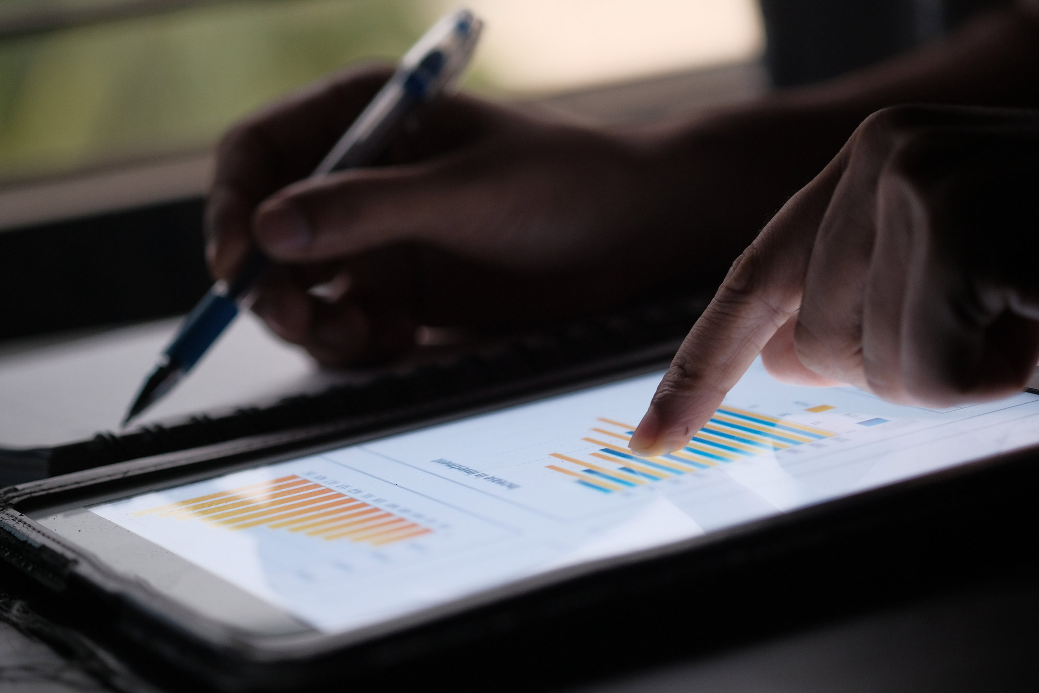 a person taking notes from the graphical values