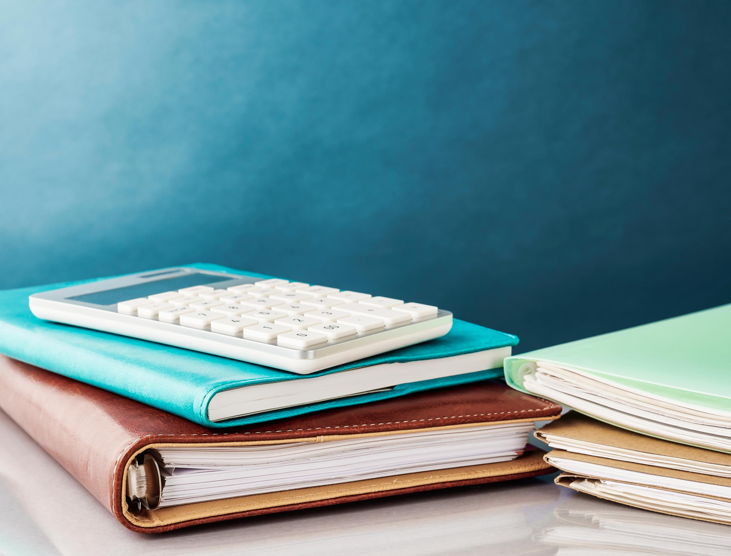 calculator and bunch of document with blue background