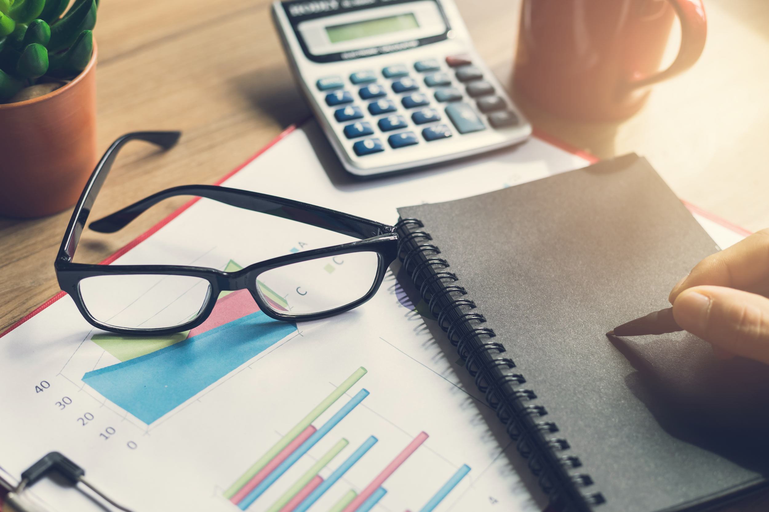 work desk with glass and calculator on top