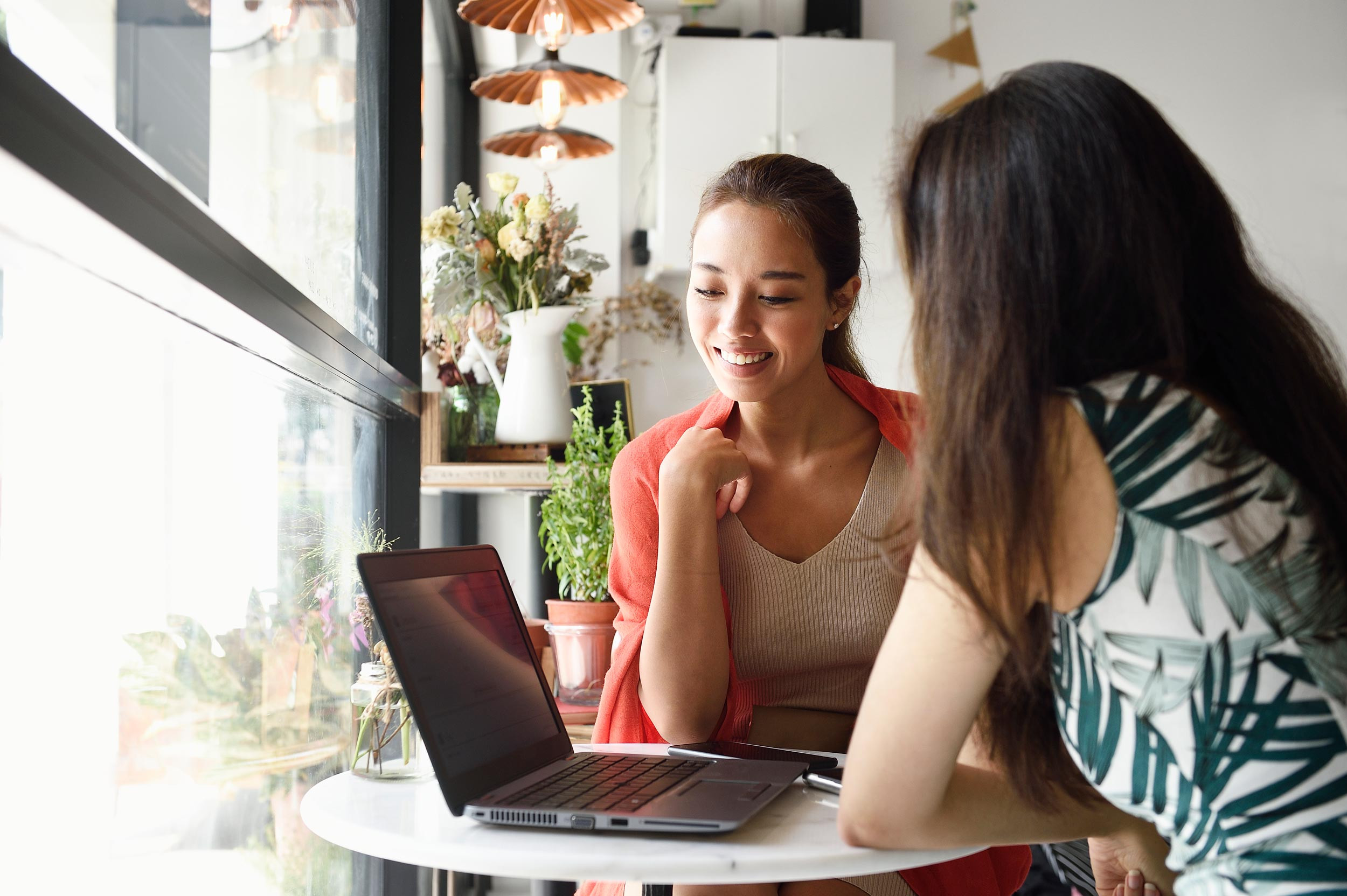 two persons with the help of laptop consulting with each other