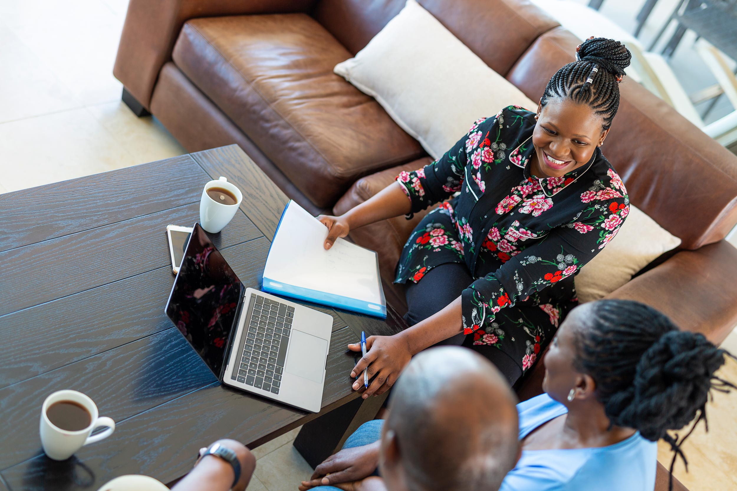 a person consulting with the couple about paperwork