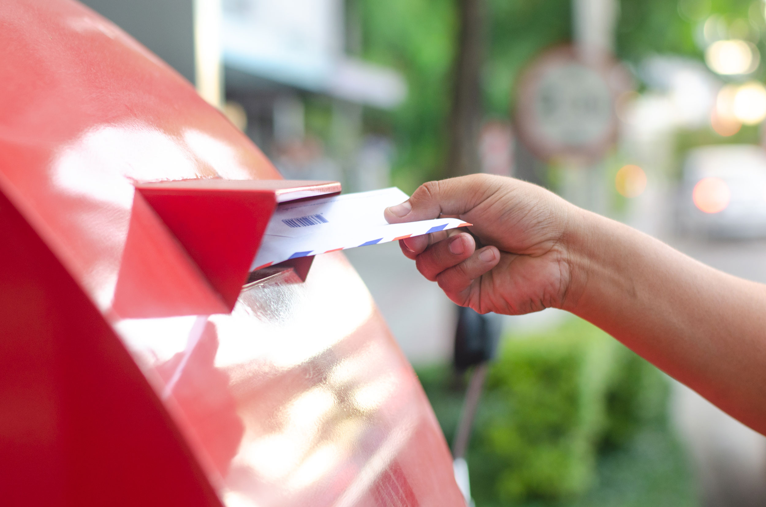 Person mailing a letter, symbolizing tax filing